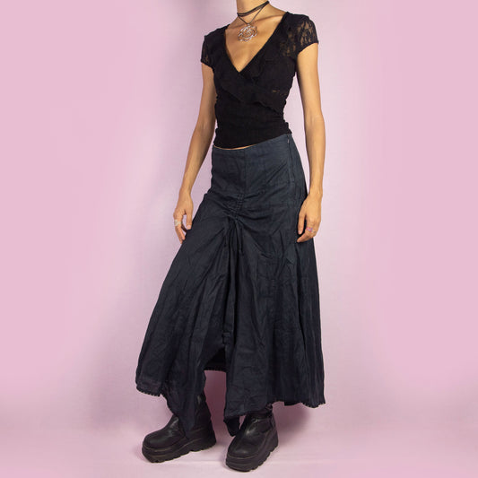 The Y2K Layered Asymmetrical Midi Skirt is a unique, avant-garde vintage 2000s dark blue-grayish piece. It features a side zipper closure, an adjustable front ruching detail, a lace-up back, and a flowy, high-low layered hemline, adding a deconstructed touch. Perfect for an avant-garde event or a casual summer night outfit.