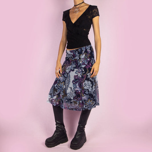 The Y2K Print Mesh Midi Skirt is a vintage 2000s piece featuring an elastic waist and a bold, artistic paisley print in dark blue, purple, and black hues. Its lightweight mesh fabric gives it a flowy, flattering A-line silhouette, perfect for summer outings or evening outfits.