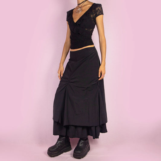 The Y2K Black Layered Midi Skirt is a vintage 2000s piece that features a unique, layered design with ruched details along the front. It includes a back zipper closure and a high-waisted fit. Perfect for both casual and night-out outfits.