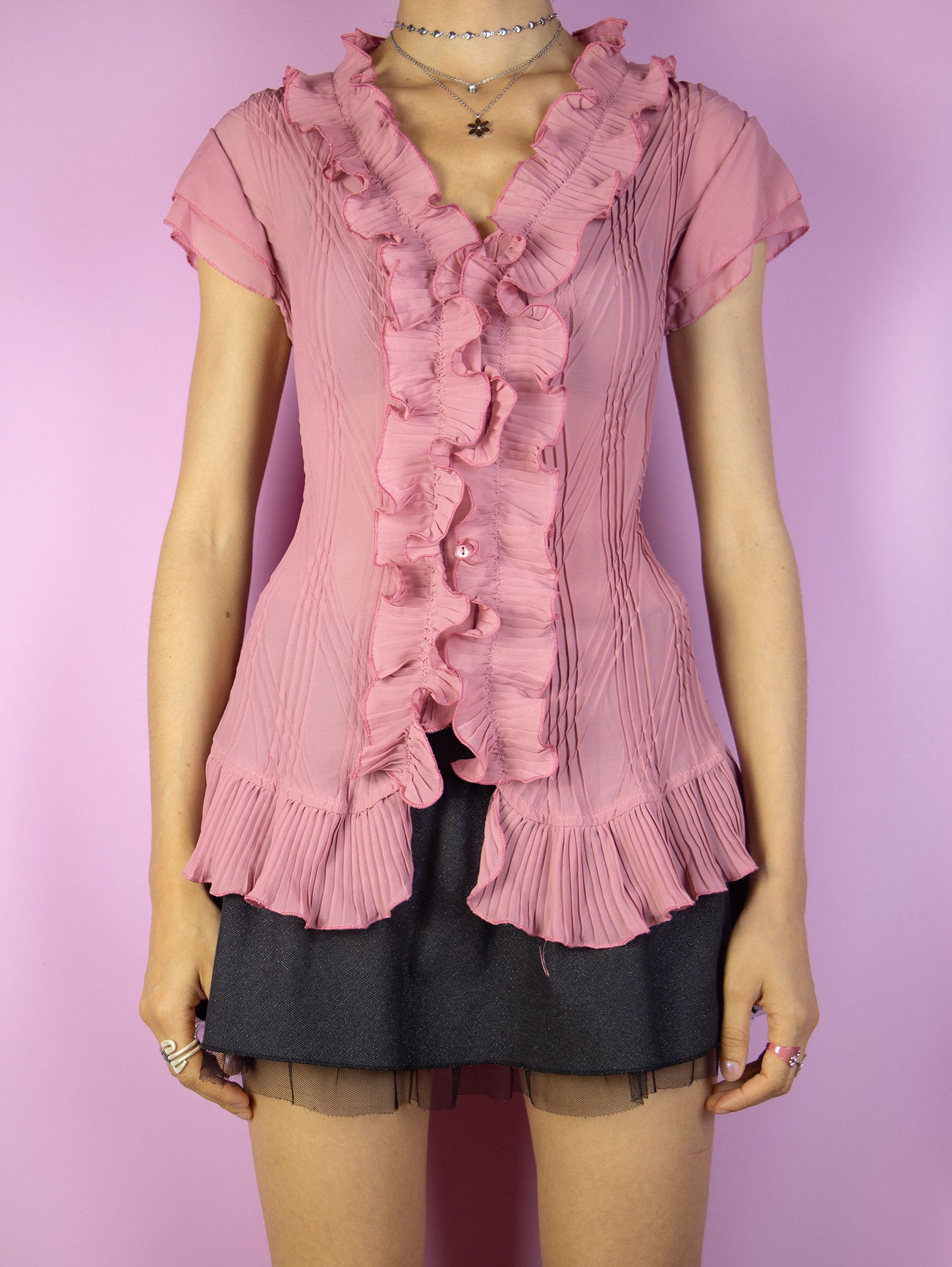 The Vintage 90s Pink Ruffle Sheer Top is a pink semi-sheer pleated ruffled sleeveless blouse with button closure. Romantic coquette 1990s summer shirt.