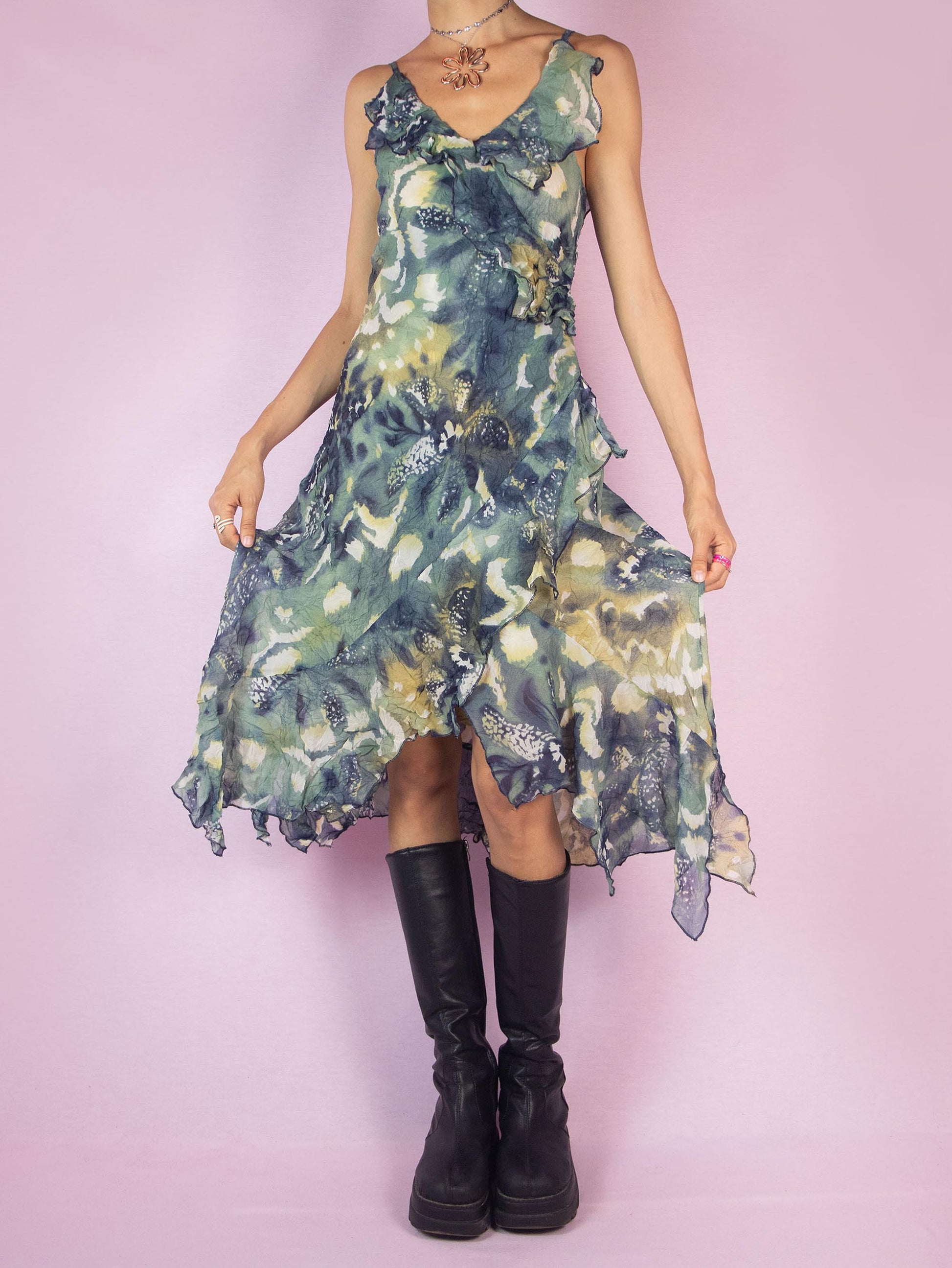 The Y2K Asymmetrical Ruffle Midi Dress is a vintage 2000s piece featuring an abstract print, delicate ruffle details along the neckline and hem, and an asymmetrical, flowy silhouette. Perfect for summer parties, evening outings, or a romantic day out.