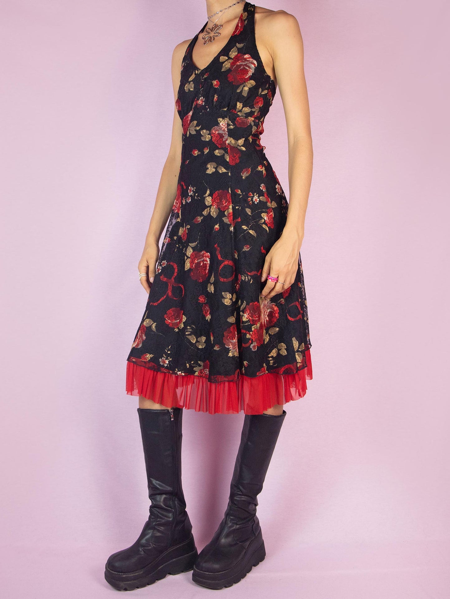 The Y2K Black Halter Lace Midi Dress is a vintage 2000s piece featuring a halter tie neck design, a red floral rose print mesh overlay, and a side zipper closure. Perfect for a summer party or a romantic evening out.