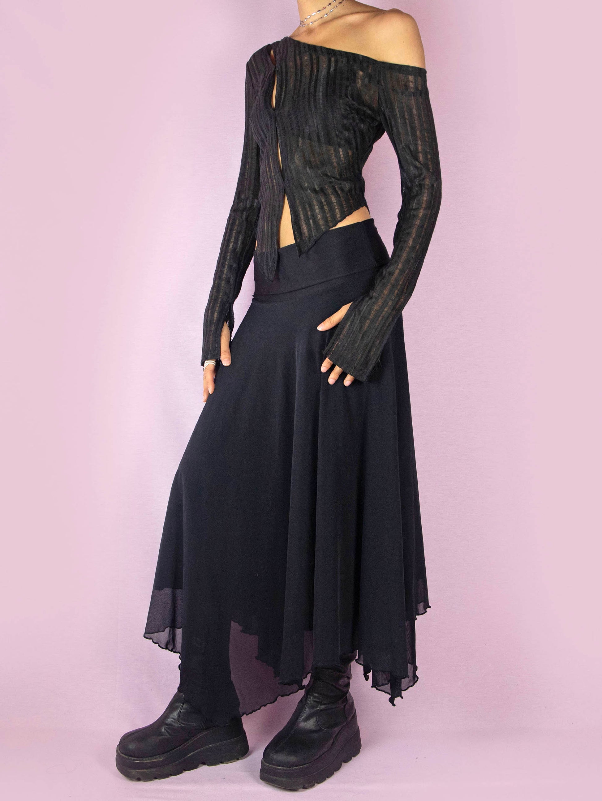 The Y2K Black Mesh Maxi Skirt is a vintage 2000s deconstructed subversive night-out party midi skirt with an elastic waist and an asymmetrical handkerchief hem.