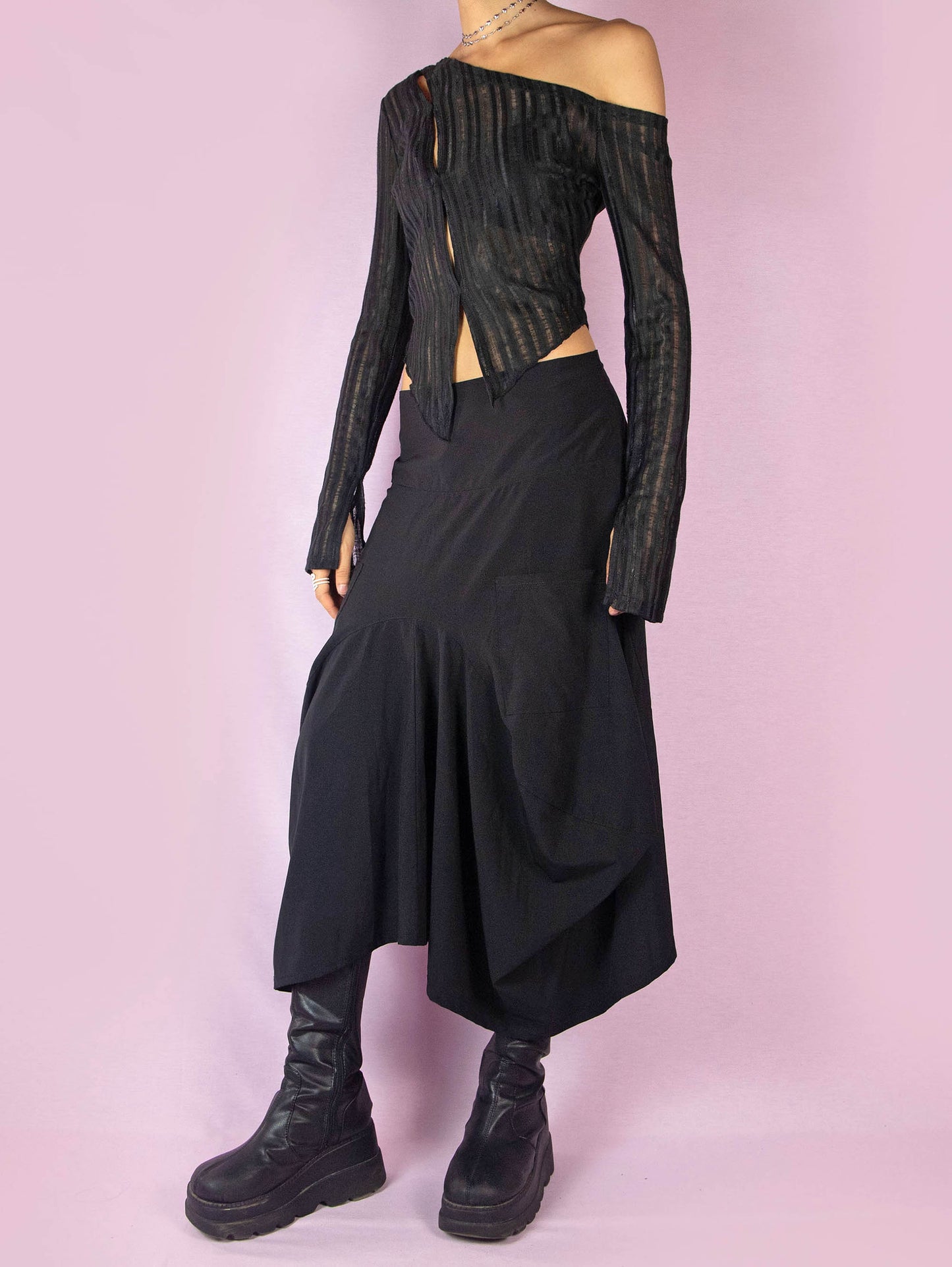 The Y2K Black Balloon Midi Skirt is a vintage 2000s avant-garde deconstructed subversive bubble-style skirt, slightly stretchy, with pockets, pleats, an asymmetrical hem, and a back zipper closure. Made in France.