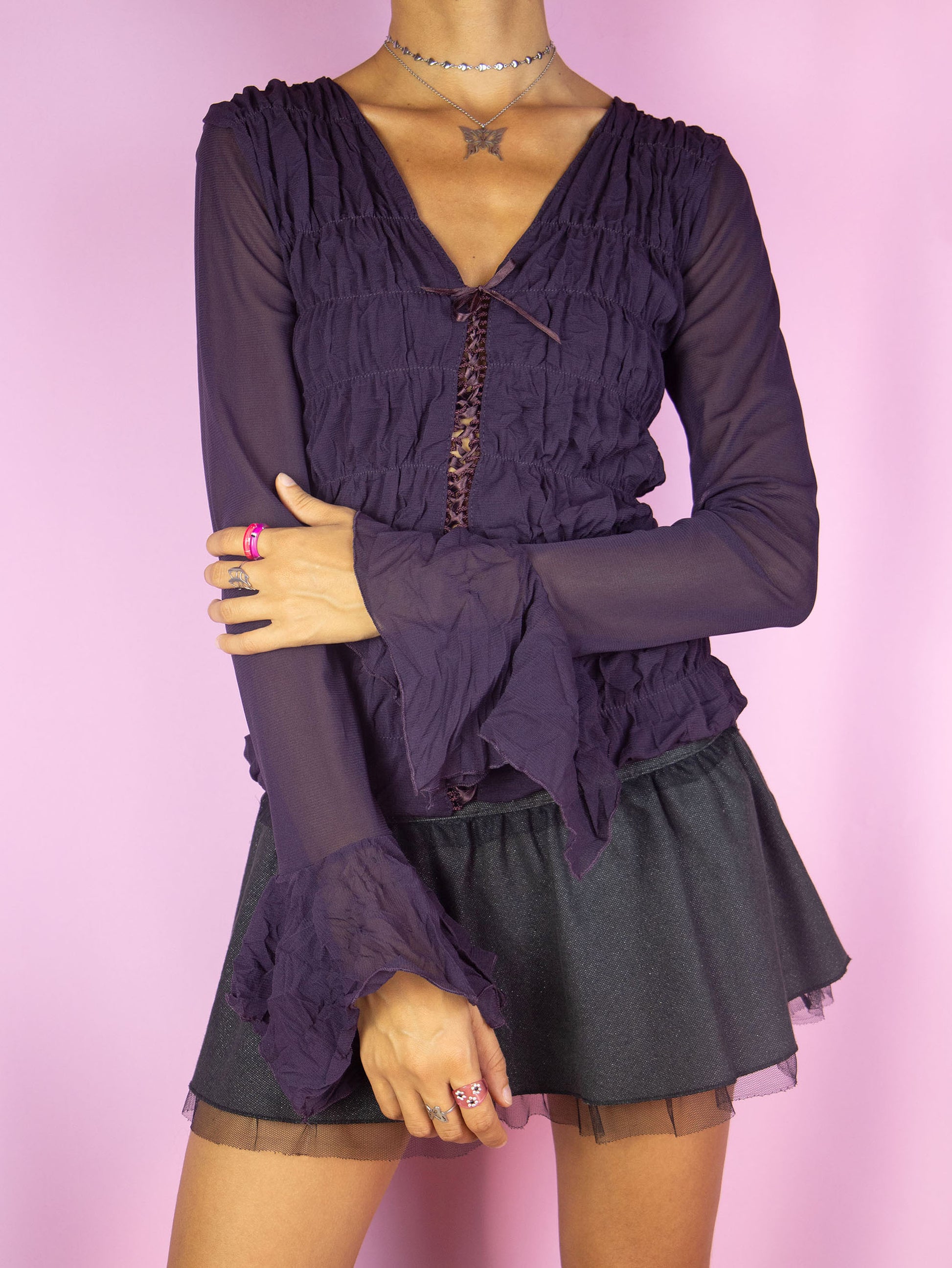 The Y2K Dark Purple Mesh Blouse is a vintage long bell sleeve ruched semi-sheer mesh dark purple top with lace-up front. Romantic fairy grunge whimsygoth 2000s shirt.