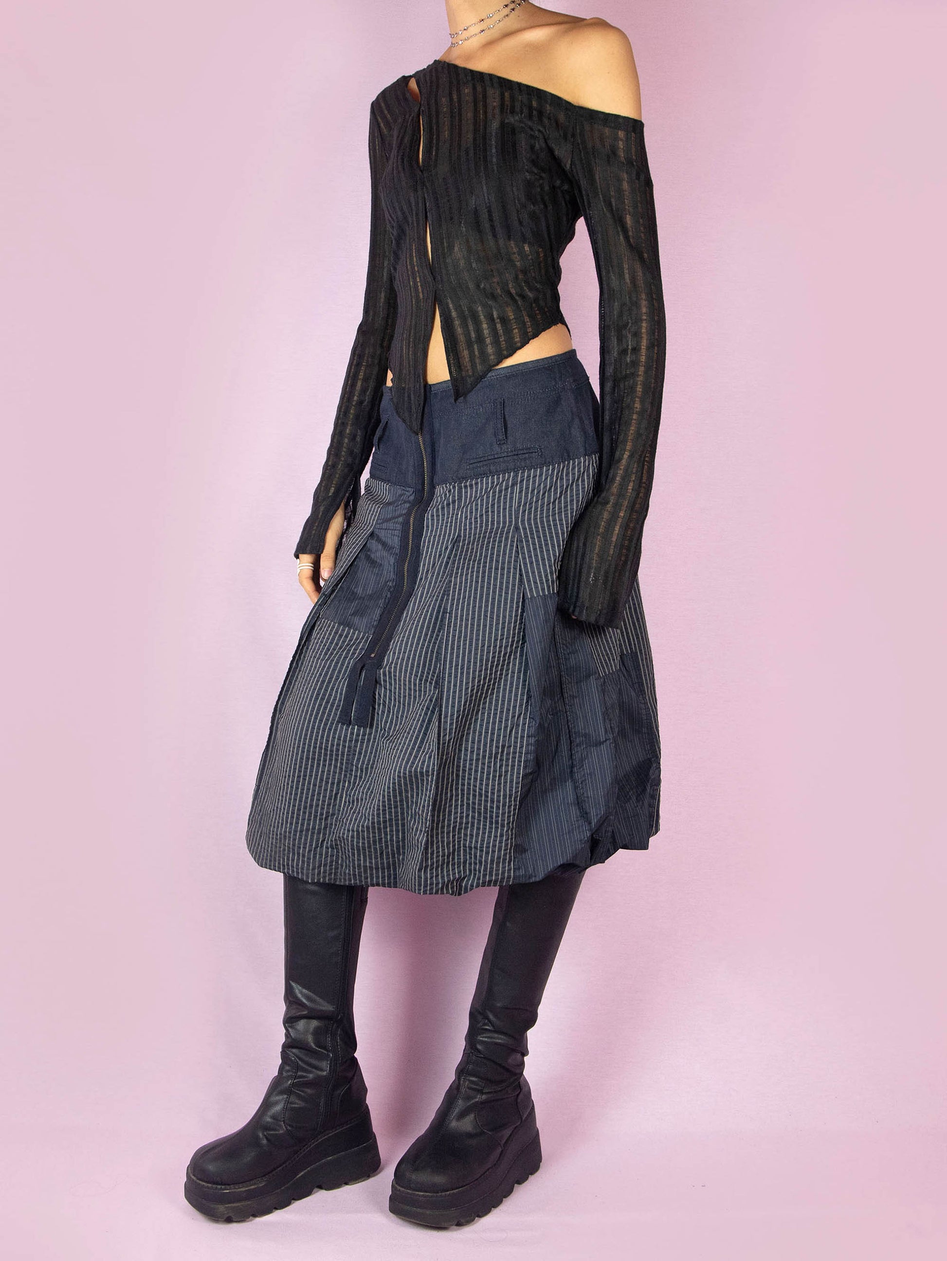 The Y2K Blue Balloon Midi Skirt is a dark navy blue vintage 2000s avant-garde subversive bubble style skirt with a pinstripe pattern and front zipper closure.