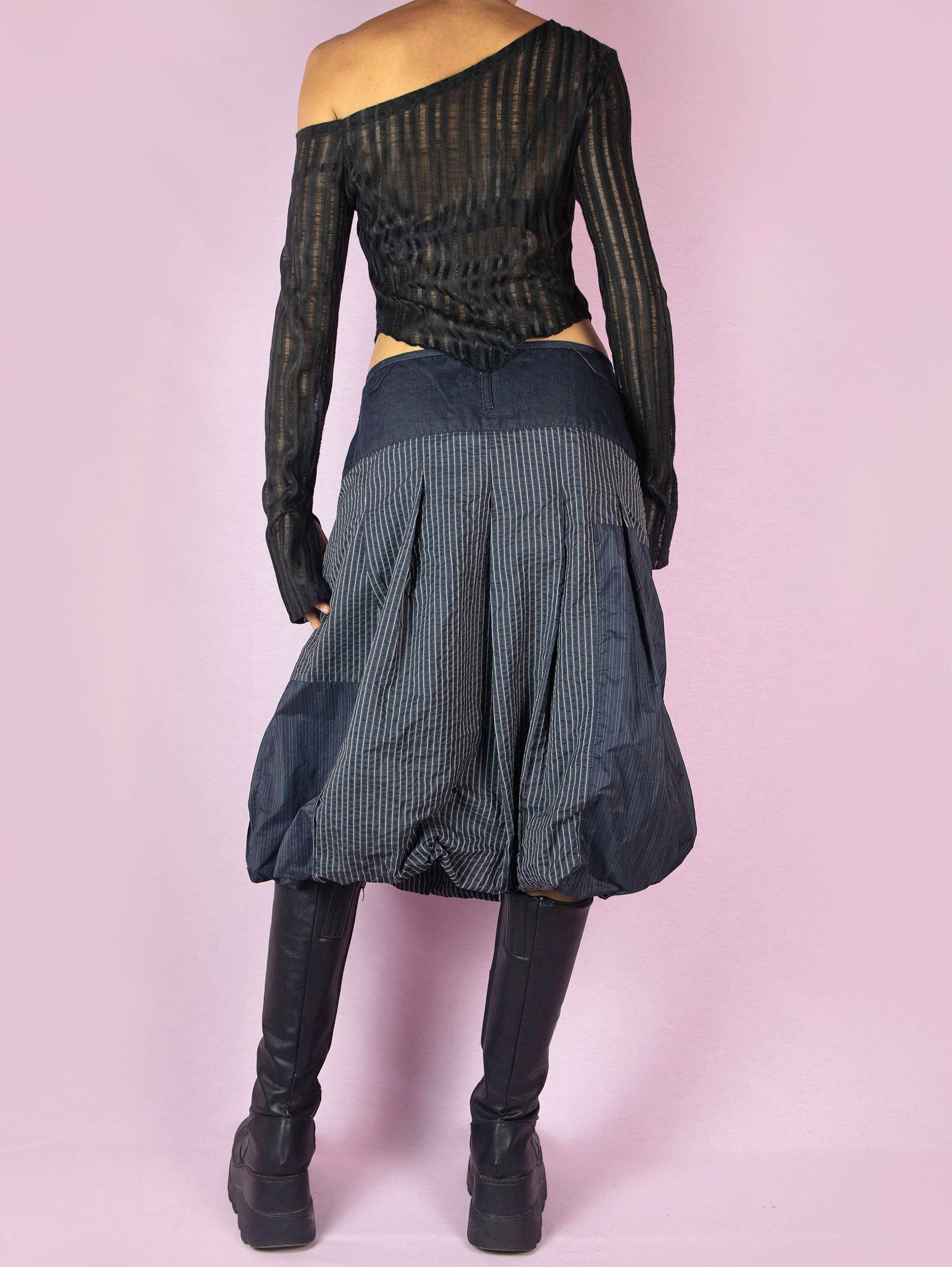 The Y2K Blue Balloon Midi Skirt is a dark navy blue vintage 2000s avant-garde subversive bubble style skirt with a pinstripe pattern and front zipper closure.