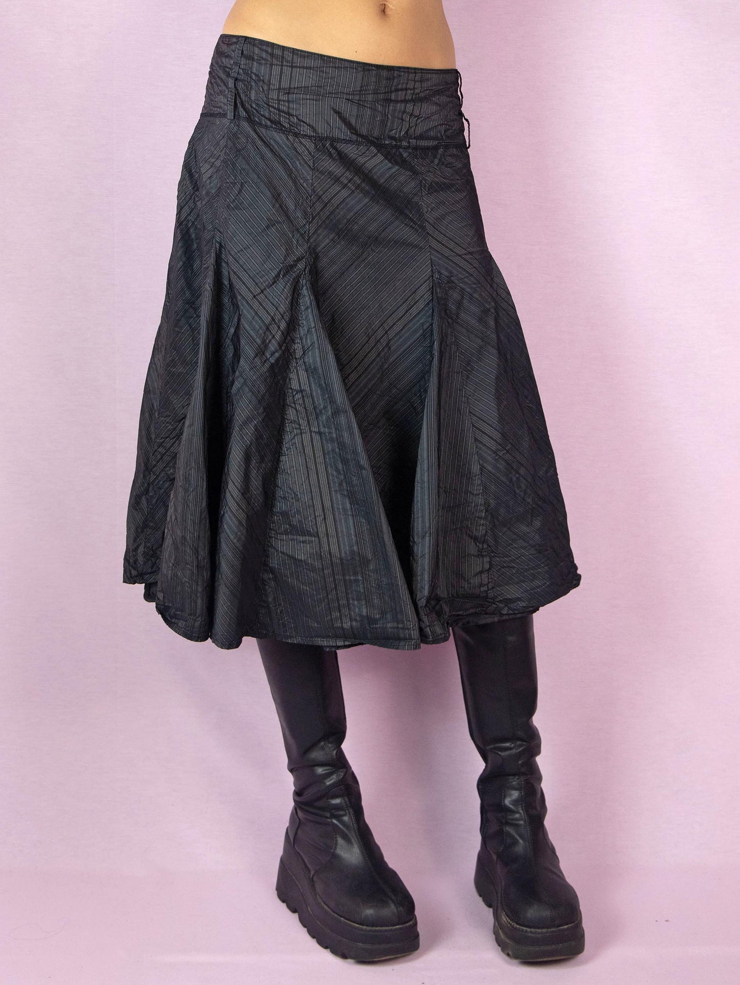 The Y2K Black Godet Circle Skirt is an elegant vintage 2000s midi skirt with a pinstripe pattern and side zipper closure.