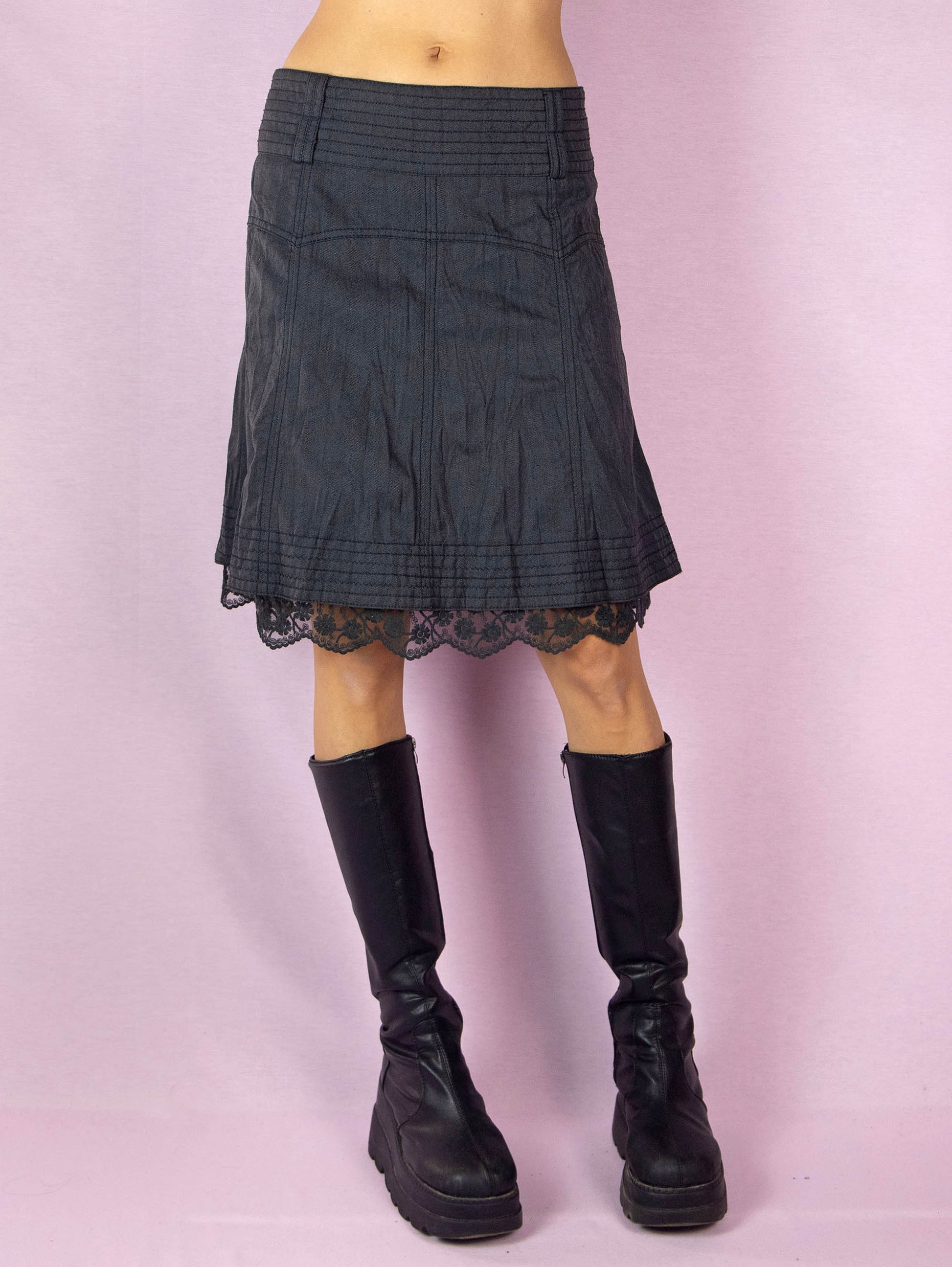 The Y2K Gray A Line Mini Skirt is a vintage 2000s casual dark gray skirt with a side zipper closure and lace detail at the hem.