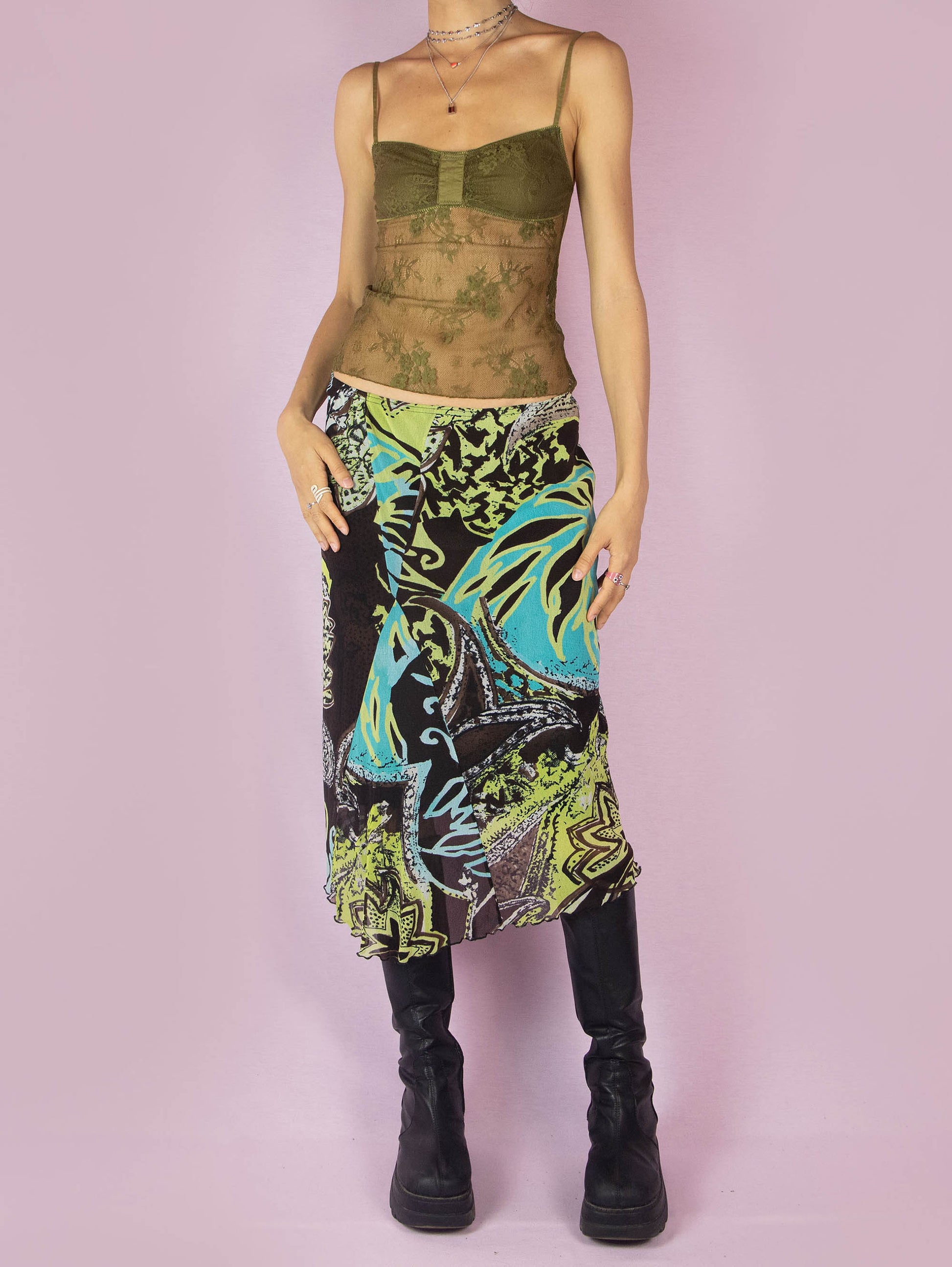 The Y2K Printed Mesh Midi Skirt is an asymmetric vintage 2000s boho summer skirt with an abstract tropical floral graphic and an elastic waist.