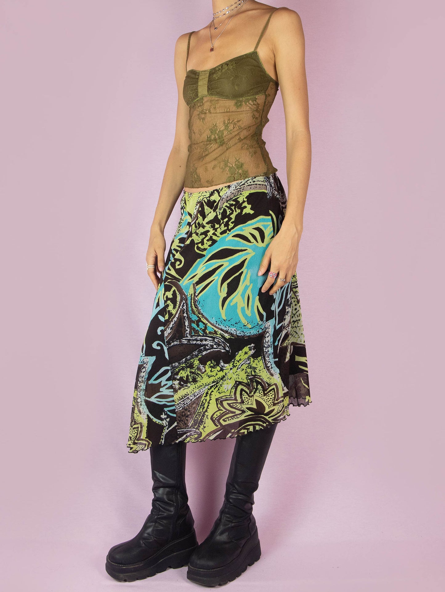 The Y2K Printed Mesh Midi Skirt is an asymmetric vintage 2000s boho summer skirt with an abstract tropical floral graphic and an elastic waist.