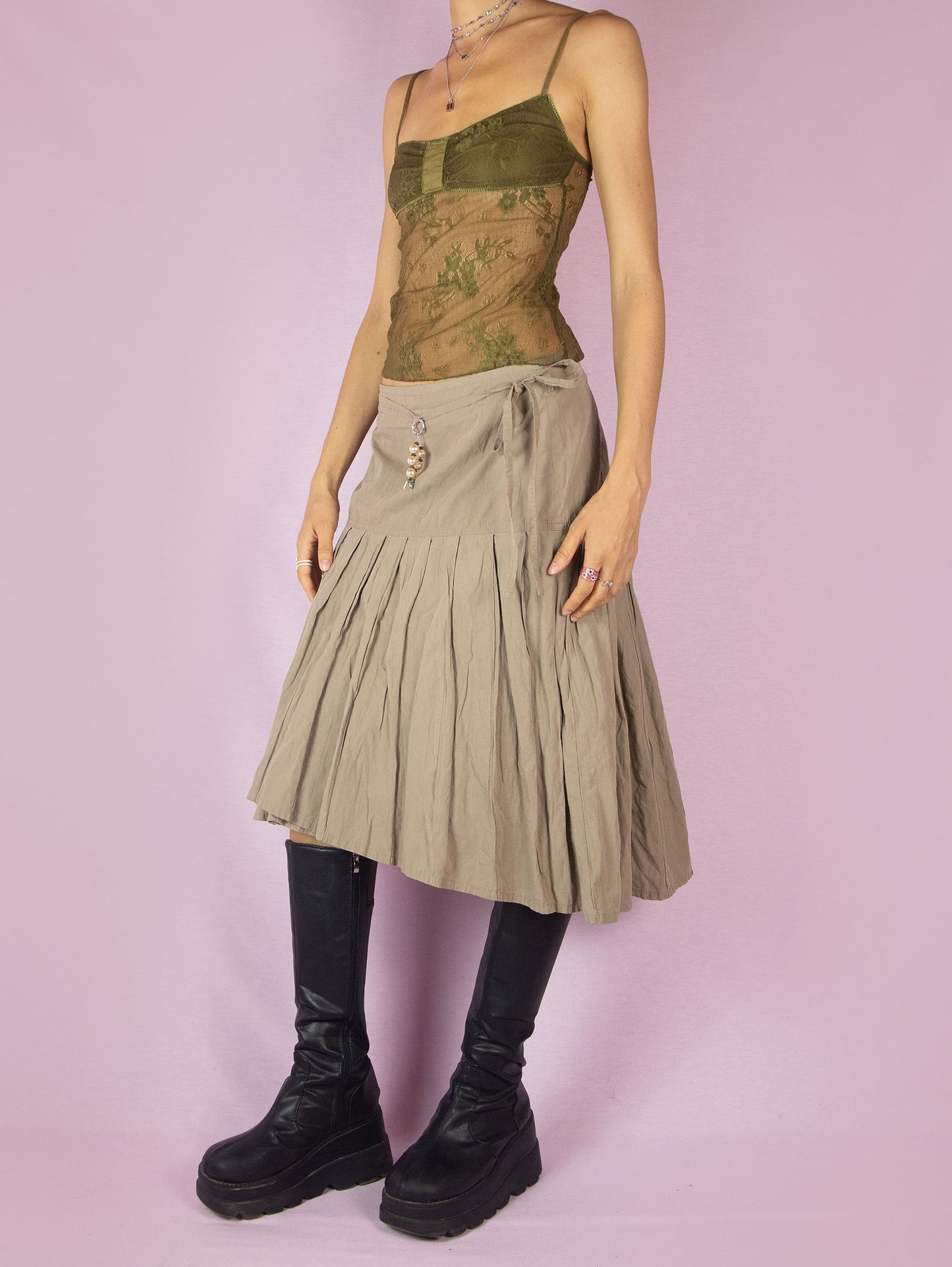 The Y2K Khaki Pleated Midi Skirt is a vintage 2000s casual minimalist beige circle A-line skirt with a back zipper closure and matching belt.