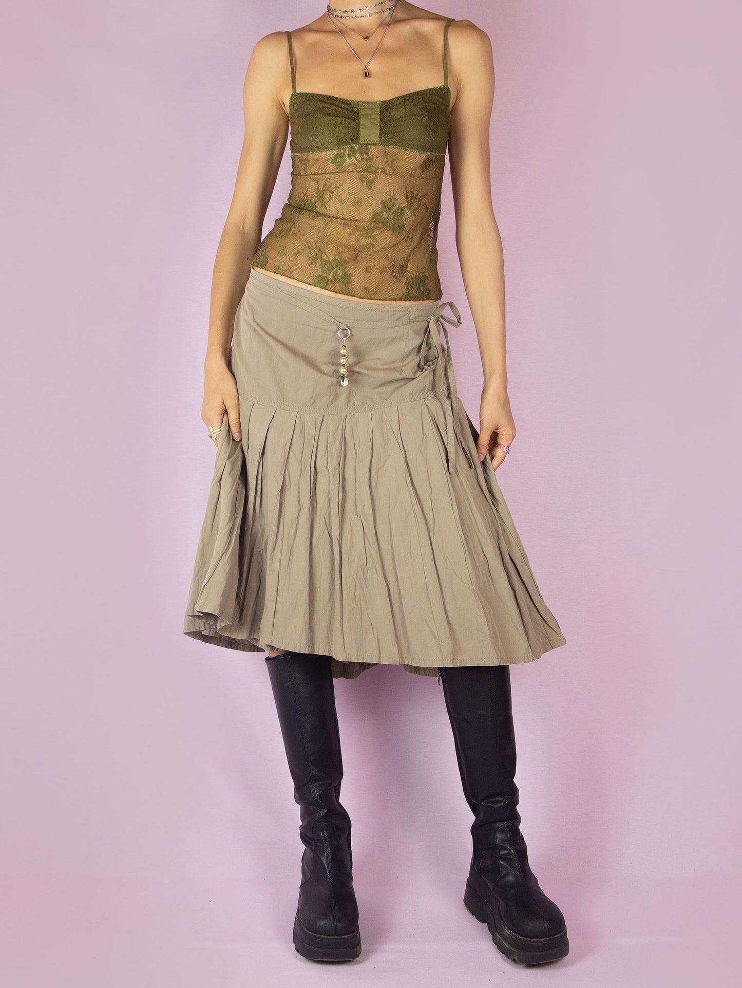 The Y2K Khaki Pleated Midi Skirt is a vintage 2000s casual minimalist beige circle A-line skirt with a back zipper closure and matching belt.