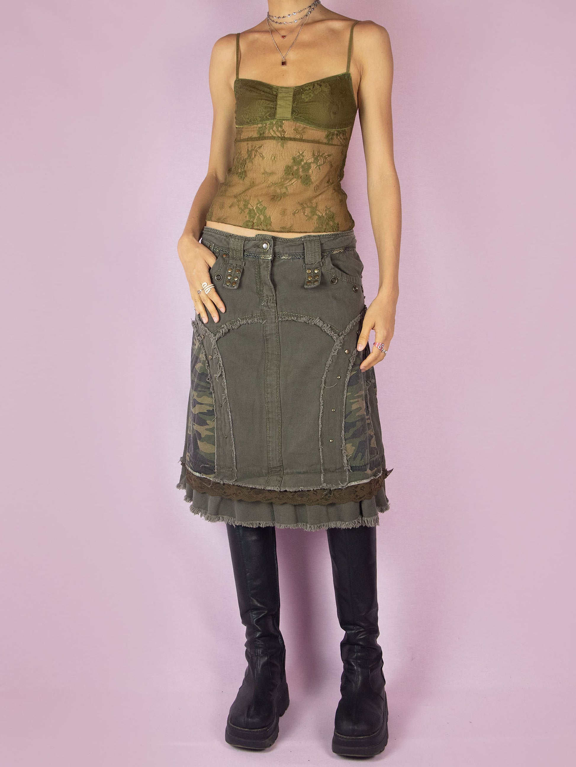 The Y2K Khaki Denim Midi Skirt is a green vintage 2000s avant-garde subversive deconstructed skirt with stud details, lace, camouflage print, ruffle hem, and frayed seams.