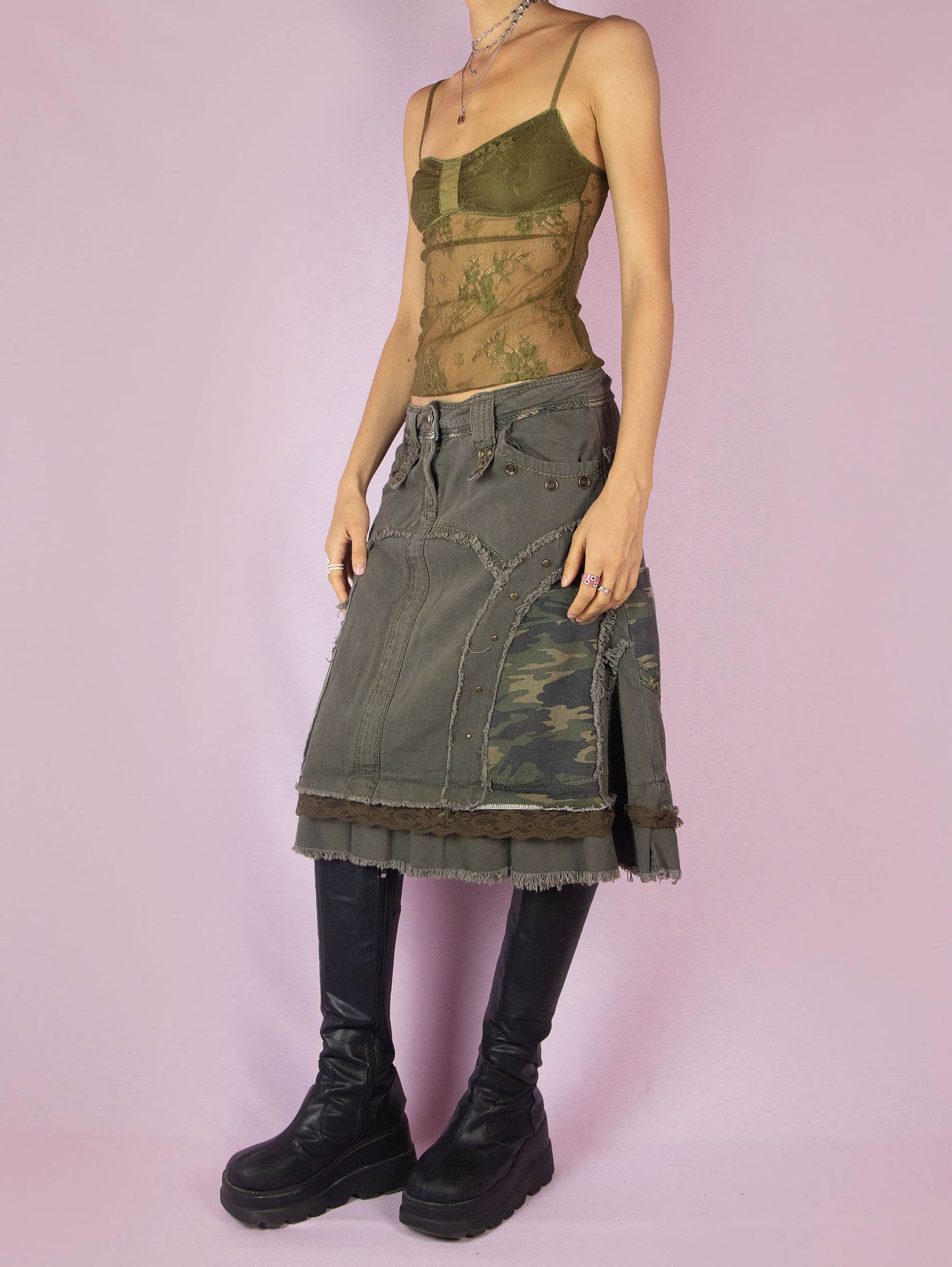 The Y2K Khaki Denim Midi Skirt is a green vintage 2000s avant-garde subversive deconstructed skirt with stud details, lace, camouflage print, ruffle hem, and frayed seams.