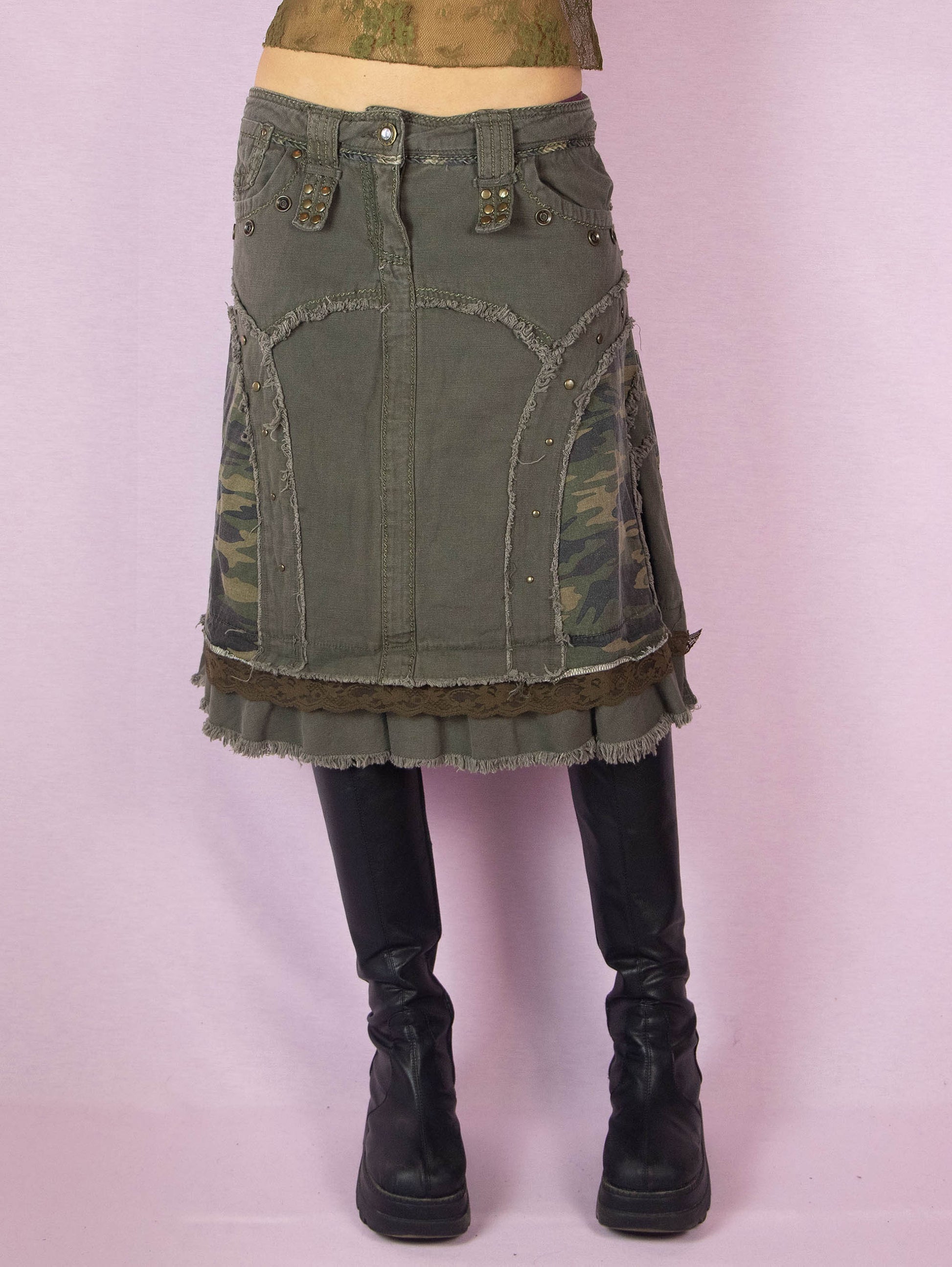 The Y2K Khaki Denim Midi Skirt is a green vintage 2000s avant-garde subversive deconstructed skirt with stud details, lace, camouflage print, ruffle hem, and frayed seams.