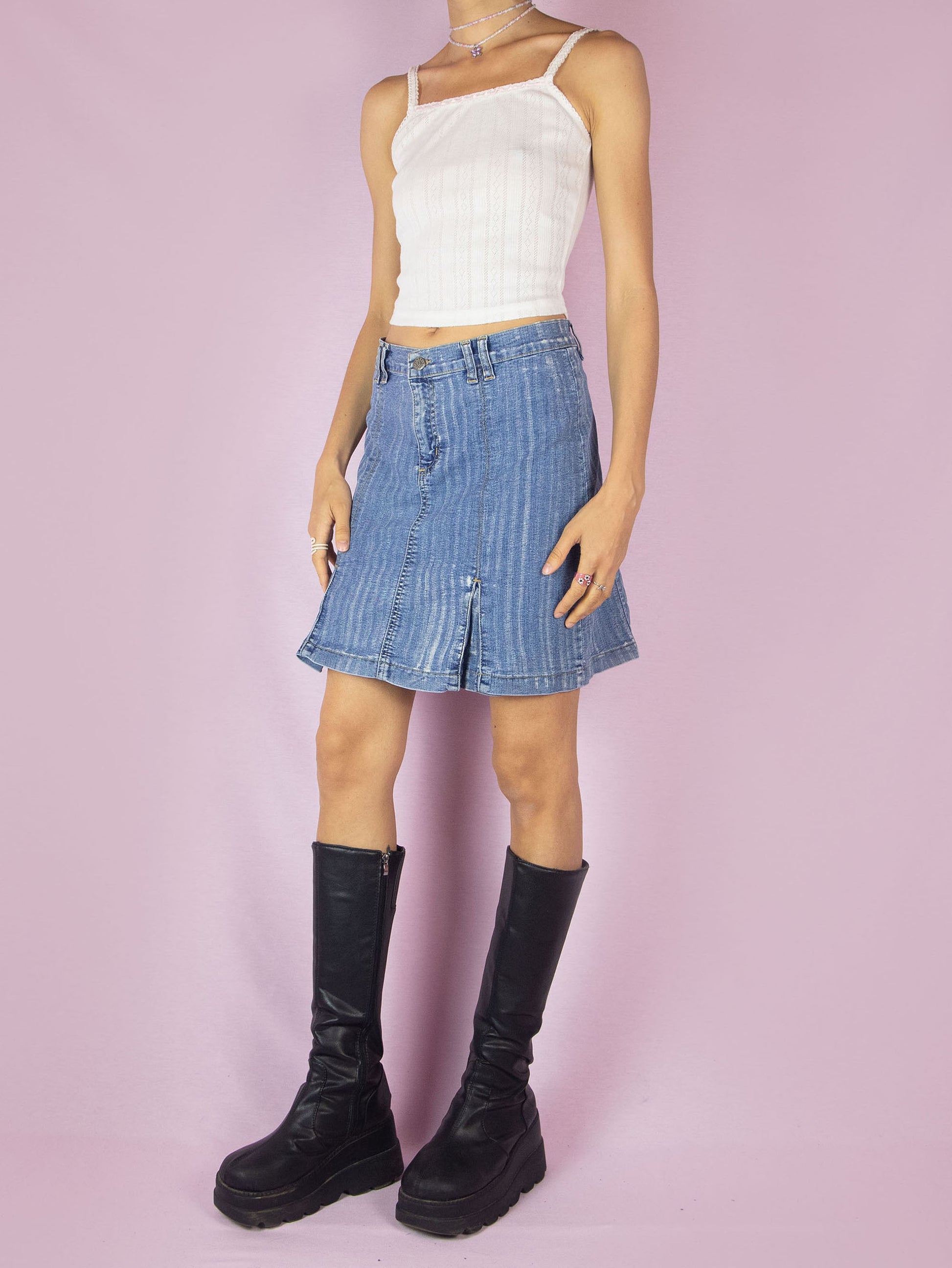 The Y2K Denim Pleated Mini Skirt is a vintage 2000s stretchy A-line jean skirt with an acid wash striped effect.