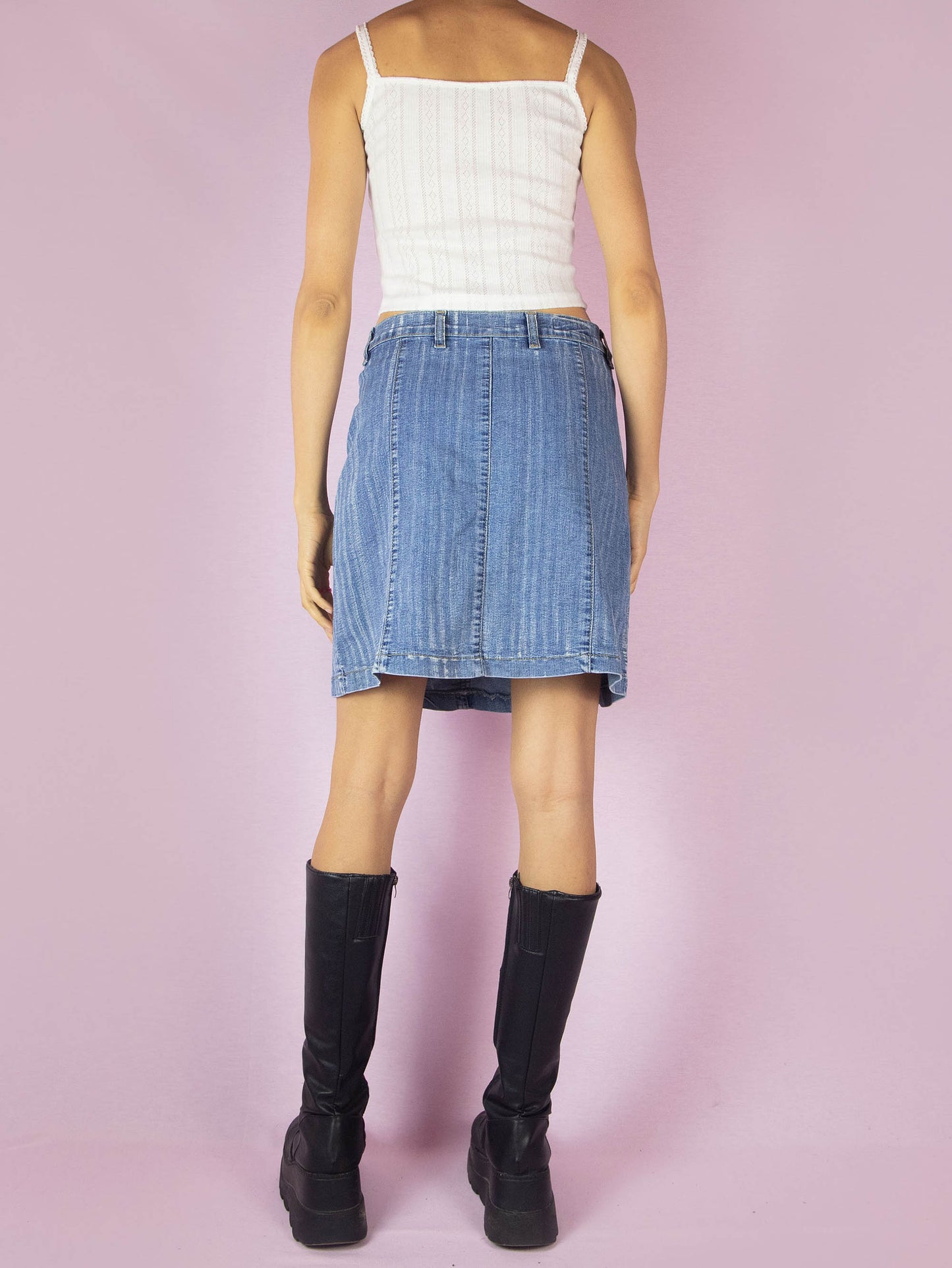 The Y2K Denim Pleated Mini Skirt is a vintage 2000s stretchy A-line jean skirt with an acid wash striped effect.