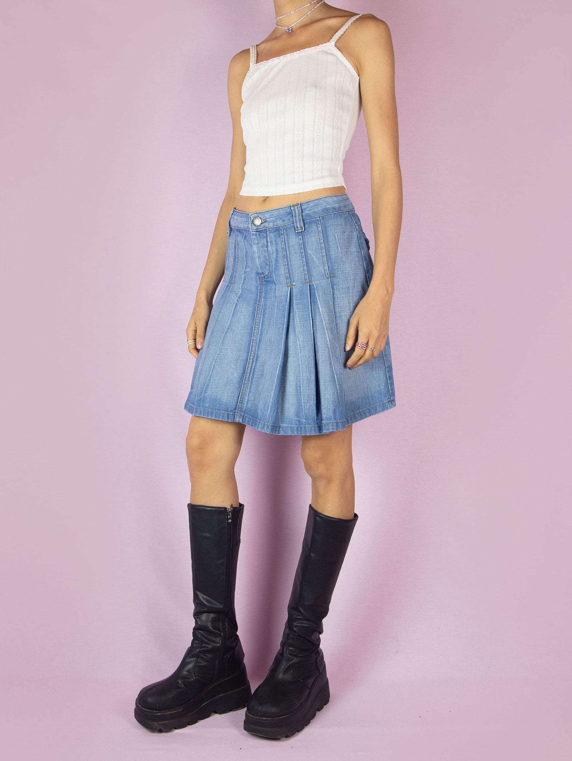 The Y2K Pleated Denim Mini Skirt is a vintage 2000s A-line jean skirt with an acid wash striped effect.