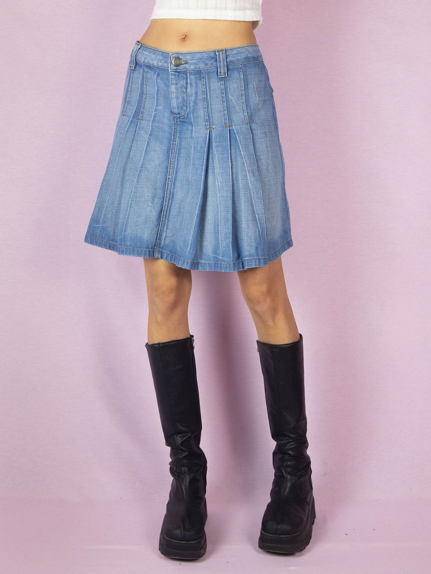 The Y2K Pleated Denim Mini Skirt is a vintage 2000s A-line jean skirt with an acid wash striped effect.