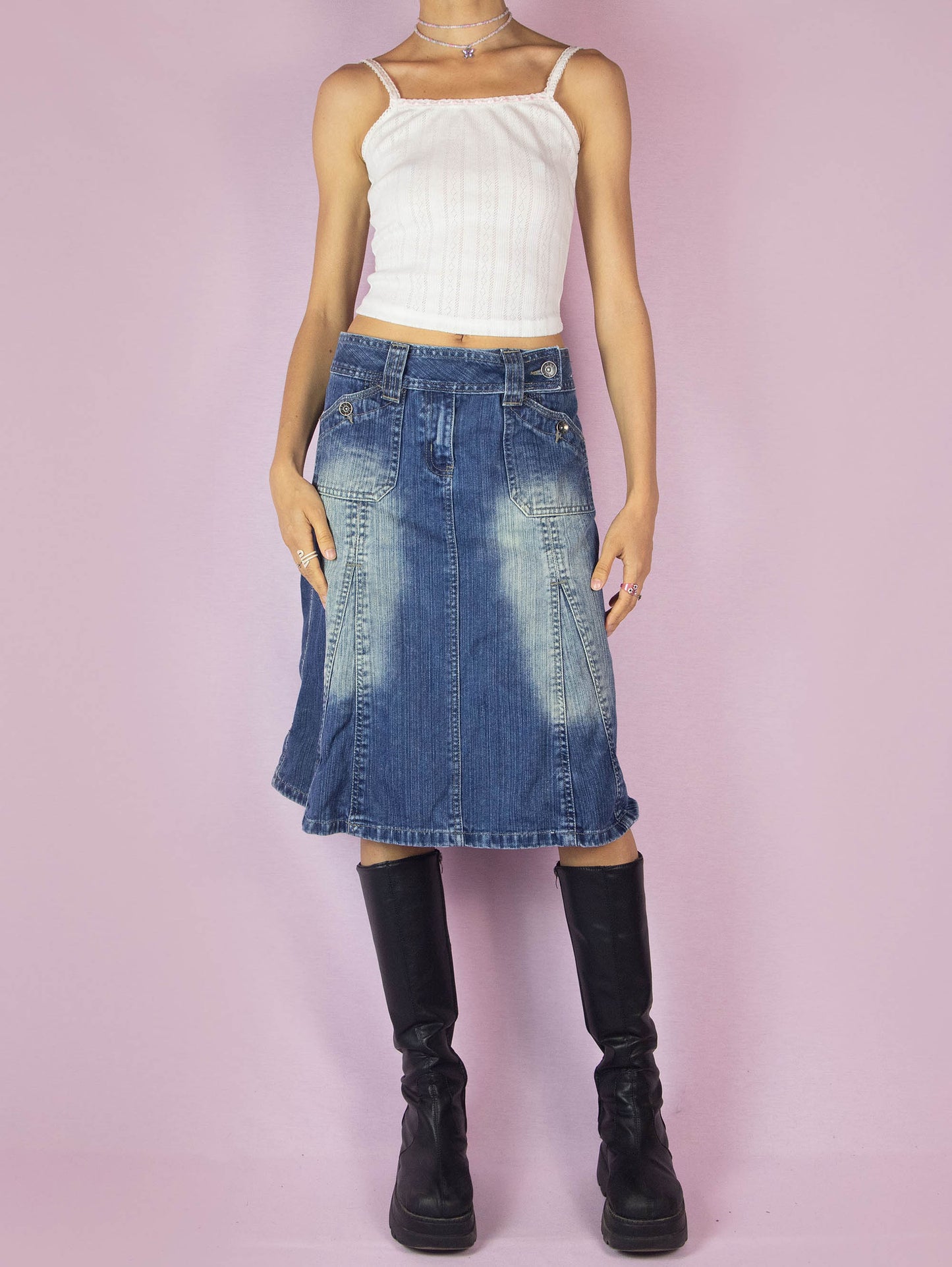 The Y2K Denim Godet A Line Skirt is a vintage 2000s subversive streetwear style jean midi skirt featuring pockets, front zipper closure, and acid wash details.