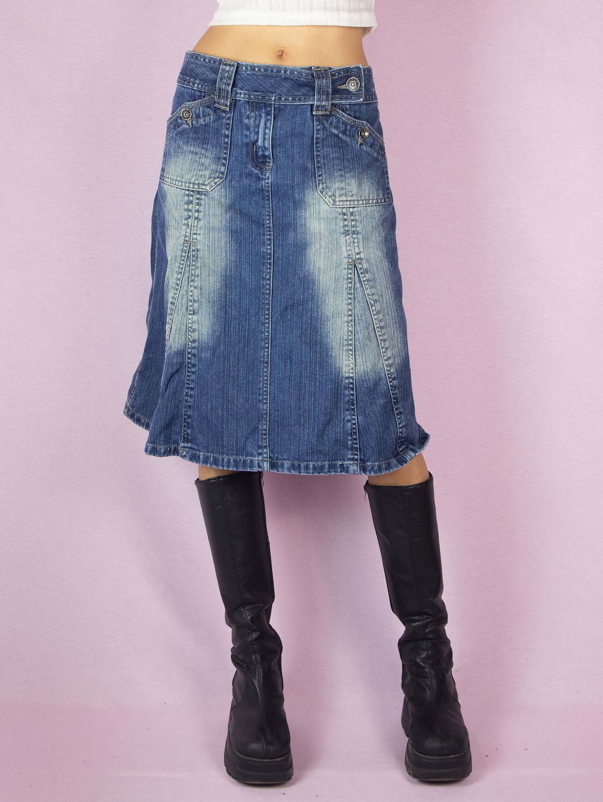 The Y2K Denim Godet A Line Skirt is a vintage 2000s subversive streetwear style jean midi skirt featuring pockets, front zipper closure, and acid wash details.