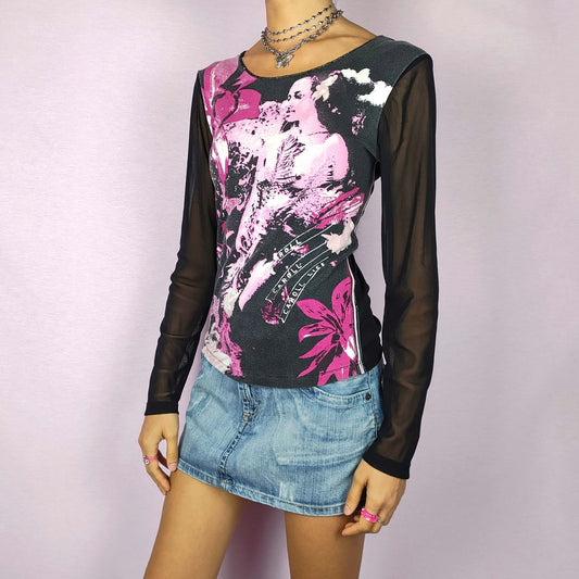 The Y2K Black Print Mesh Top is a vintage 2000s stretchy piece featuring a pink and white graphic print across the front and sheer black mesh long sleeves. Perfect for casual wear or dressing up for a night out.