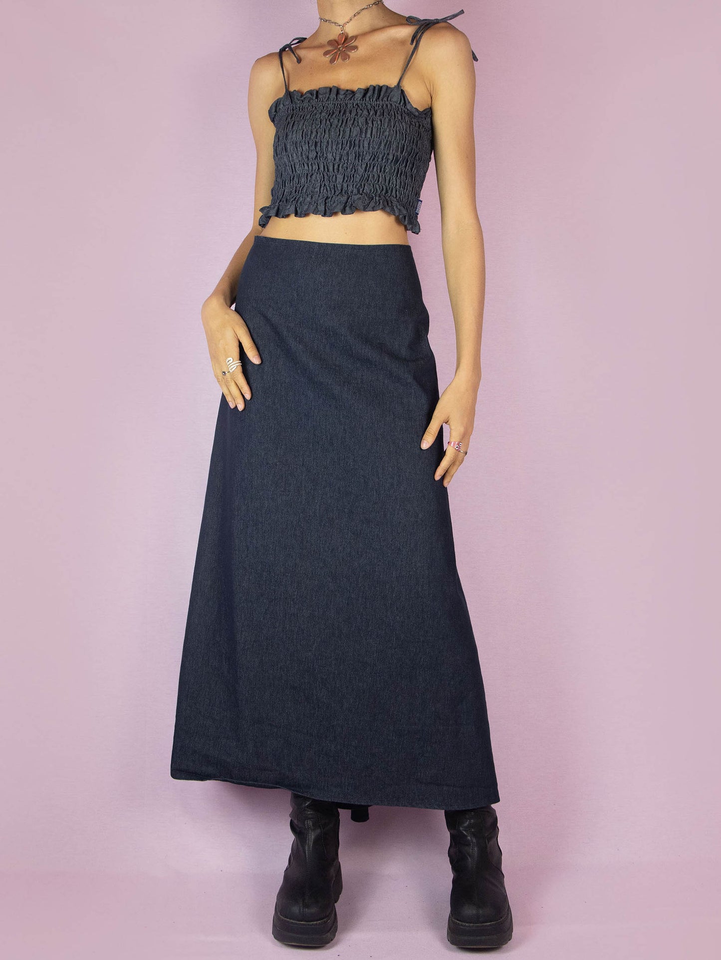 The Y2K Denim Asymmetric Maxi Skirt is a stretchy dark jean vintage 2000s subversive deconstructed A-line midi skirt with a back zipper closure.