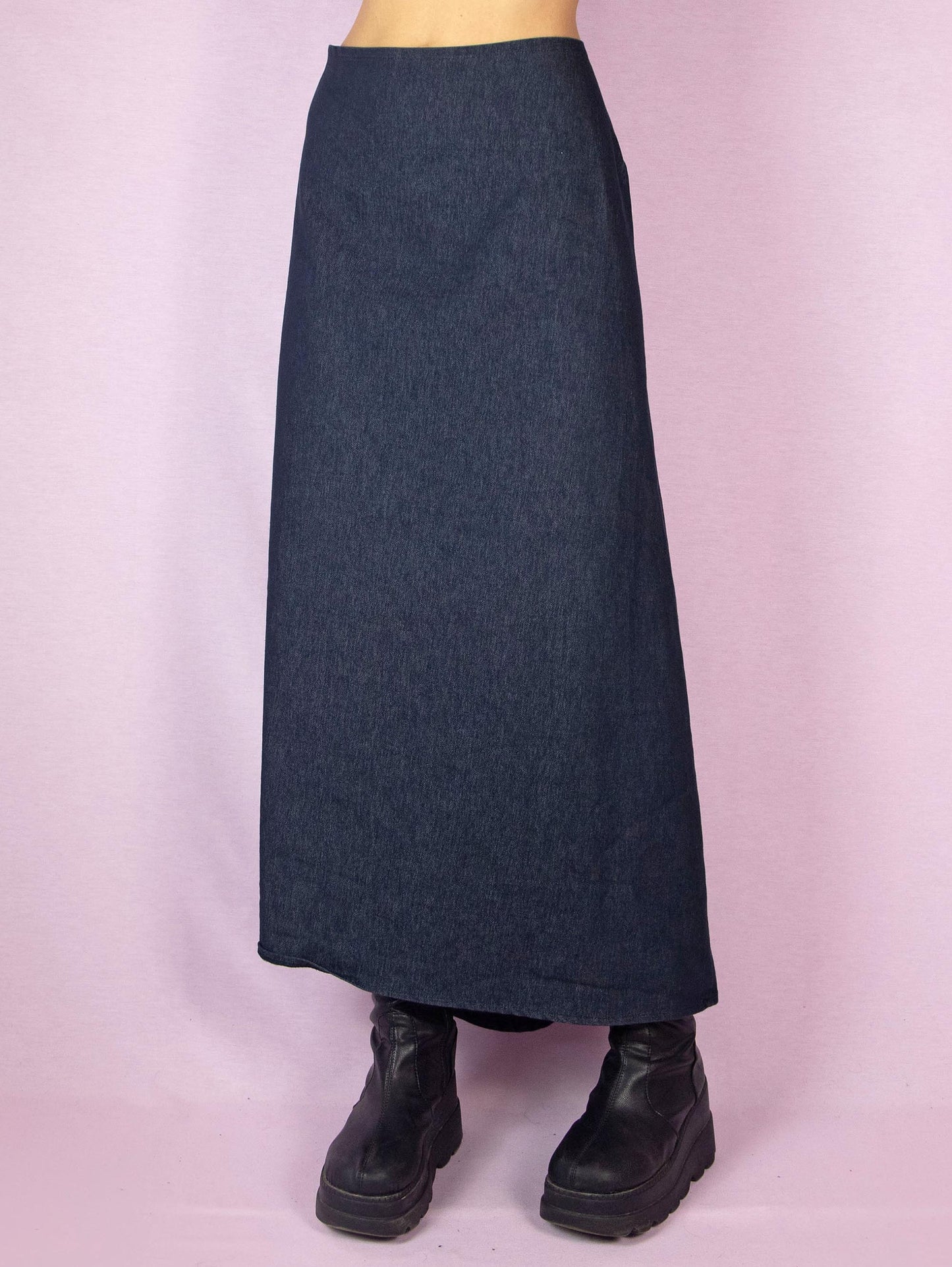 The Y2K Denim Asymmetric Maxi Skirt is a stretchy dark jean vintage 2000s subversive deconstructed A-line midi skirt with a back zipper closure.