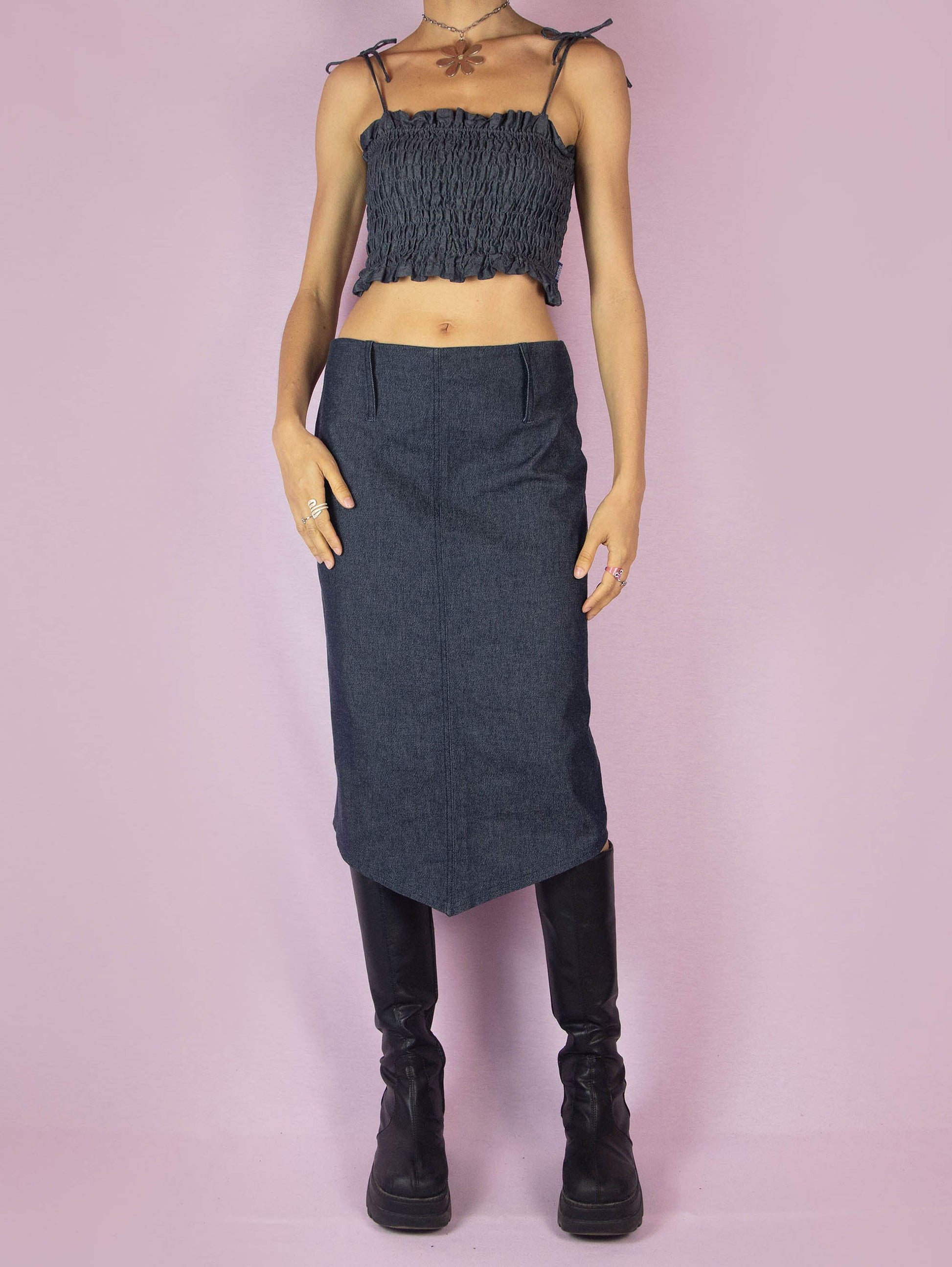 The Y2K Dark Denim Midi Skirt is a vintage 2000s a-line stretchy skirt with a side zipper closure and an asymmetrical pointed hem.