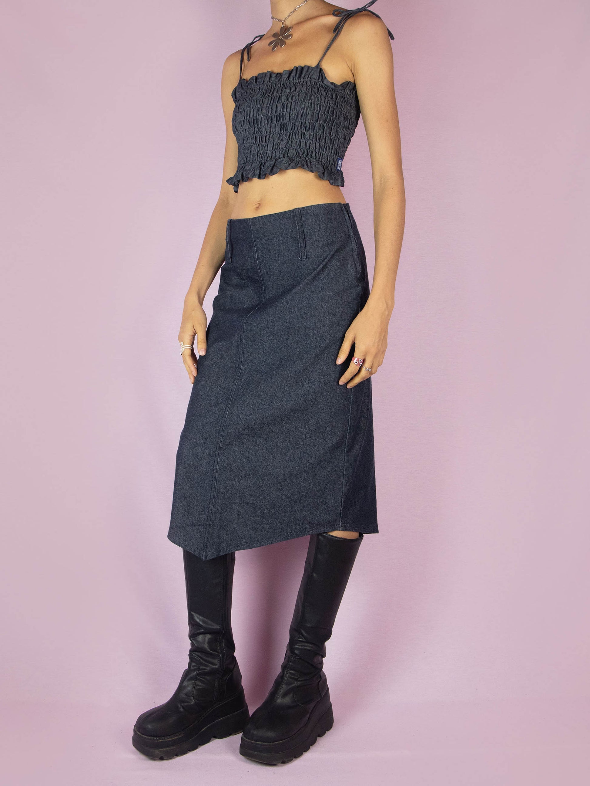 The Y2K Dark Denim Midi Skirt is a vintage 2000s a-line stretchy skirt with a side zipper closure and an asymmetrical pointed hem.