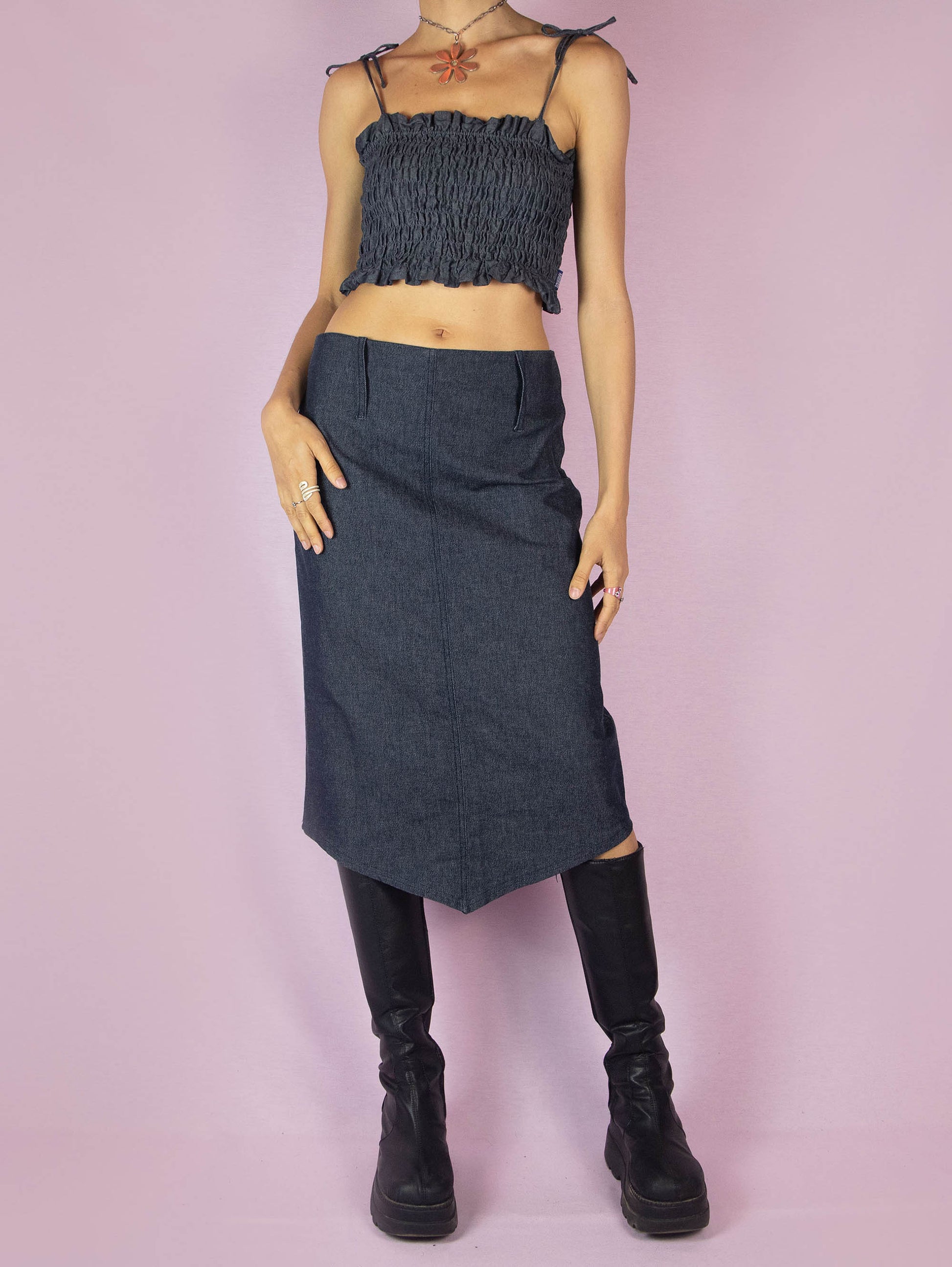 The Y2K Dark Denim Midi Skirt is a vintage 2000s a-line stretchy skirt with a side zipper closure and an asymmetrical pointed hem.