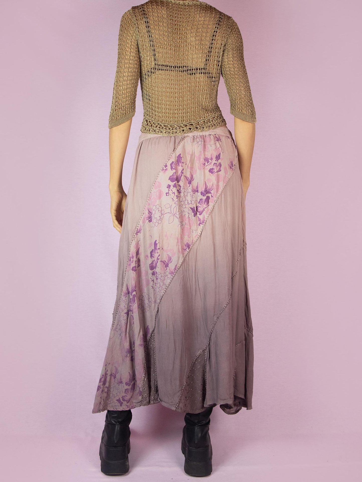 The Vintage 90s Purple A Line Midi Skirt is a dusty pinkish-purple ombre pattern boho maxi skirt with adorned with embroidered floral details, embellished with sequins and beads, and featuring an elastic waistband.