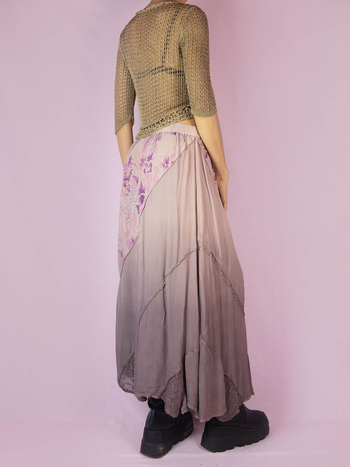 The Vintage 90s Purple A Line Midi Skirt is a dusty pinkish-purple ombre pattern boho maxi skirt with adorned with embroidered floral details, embellished with sequins and beads, and featuring an elastic waistband.