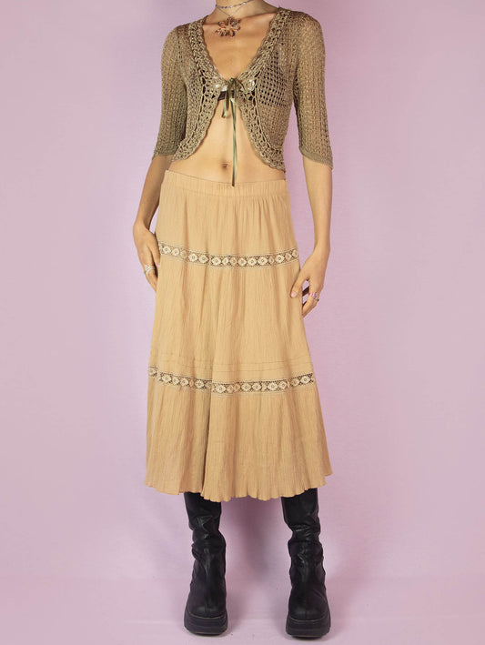 The Vintage 90s Beige Tiered Peasant Skirt is a boho midi circle skirt with an elastic waistband.