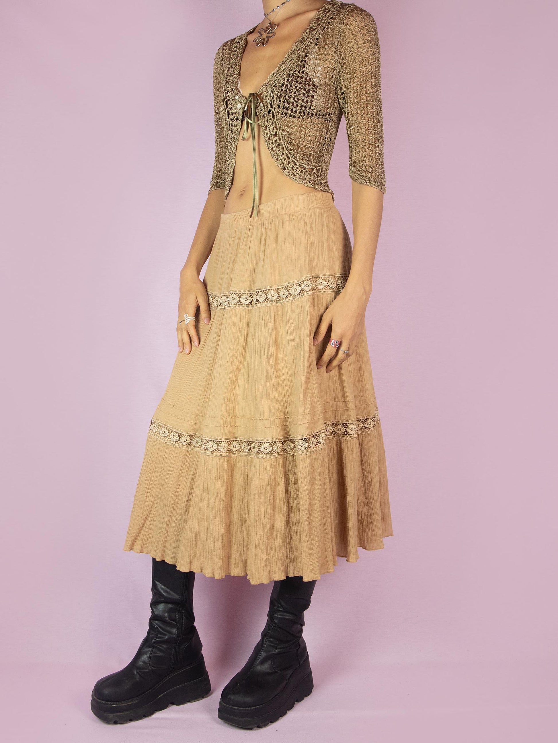 The Vintage 90s Beige Tiered Peasant Skirt is a boho midi circle skirt with an elastic waistband.