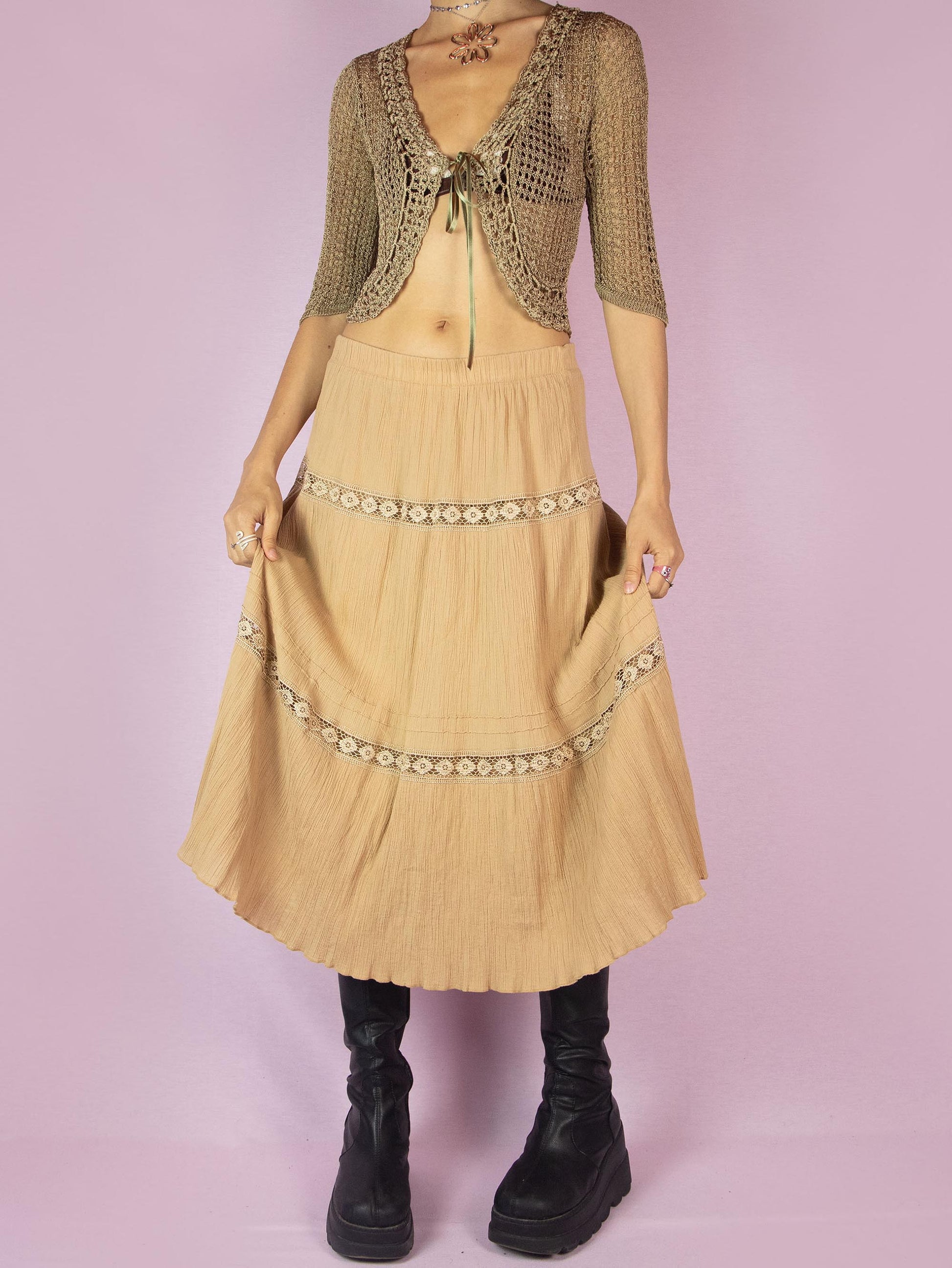 The Vintage 90s Beige Tiered Peasant Skirt is a boho midi circle skirt with an elastic waistband.