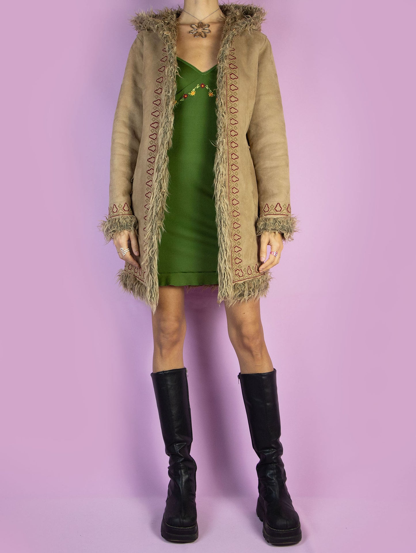 The Y2K Beige Hooded Afghan Coat is a vintage light brown beige faux suede coat with faux fur interior, collar, and cuffs. It also features a hood, pockets, and hook closure. Boho fairy grunge whimsygoth 2000s penny lane winter statement jacket.