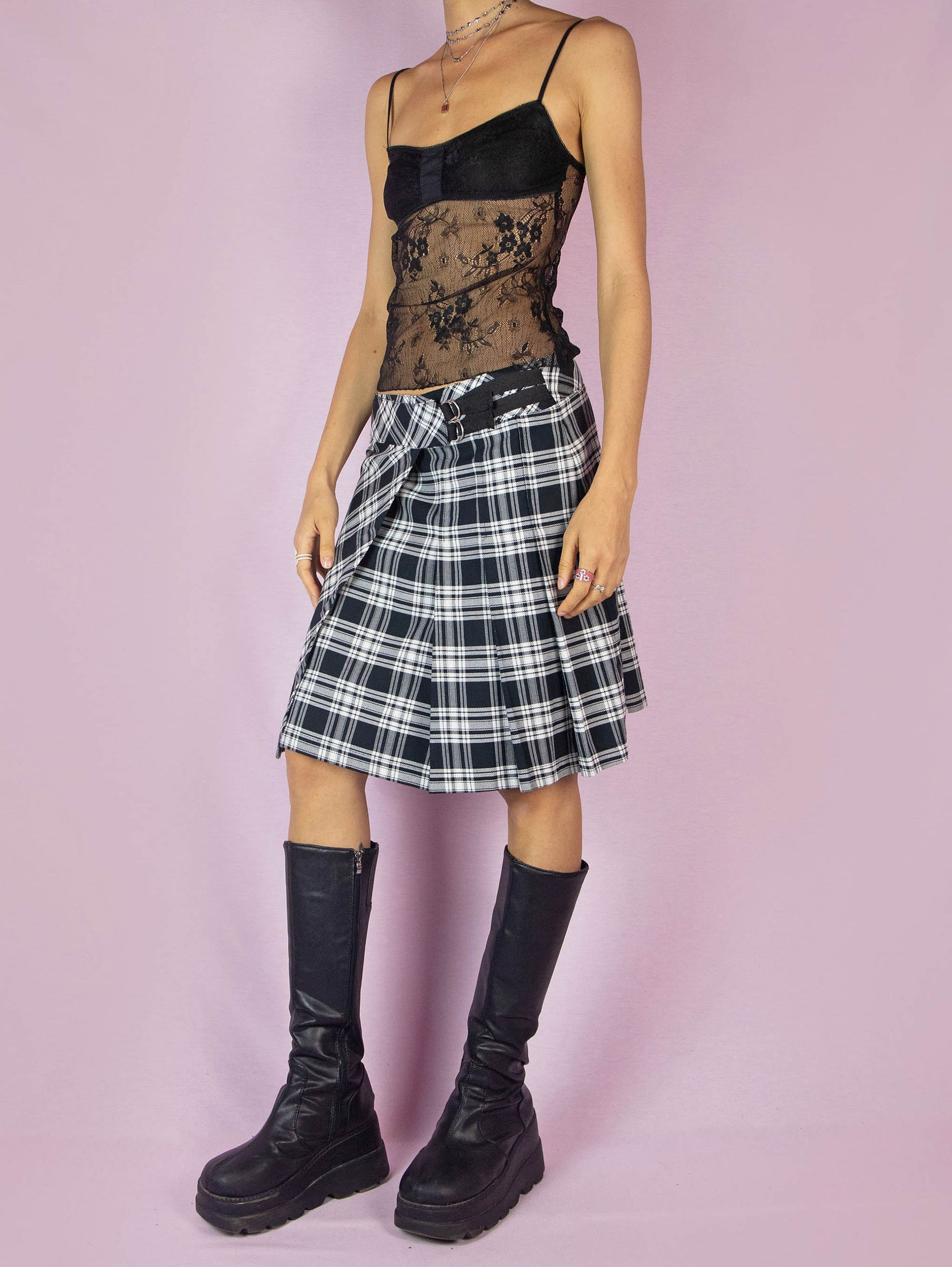 The Y2K Plaid Check Wrap Skirt is a vintage 2000s preppy school-style black and white pleated knit midi skirt.