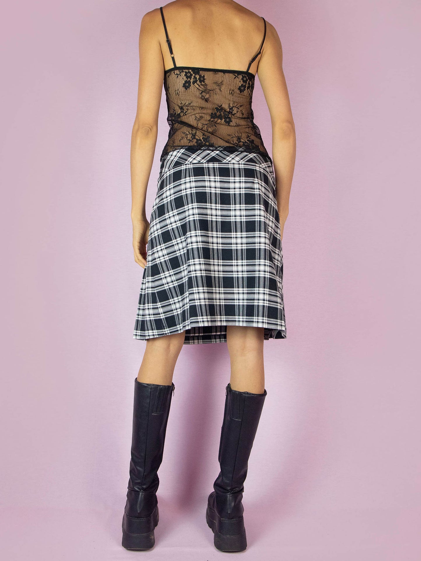 The Y2K Plaid Check Wrap Skirt is a vintage 2000s preppy school-style black and white pleated knit midi skirt.