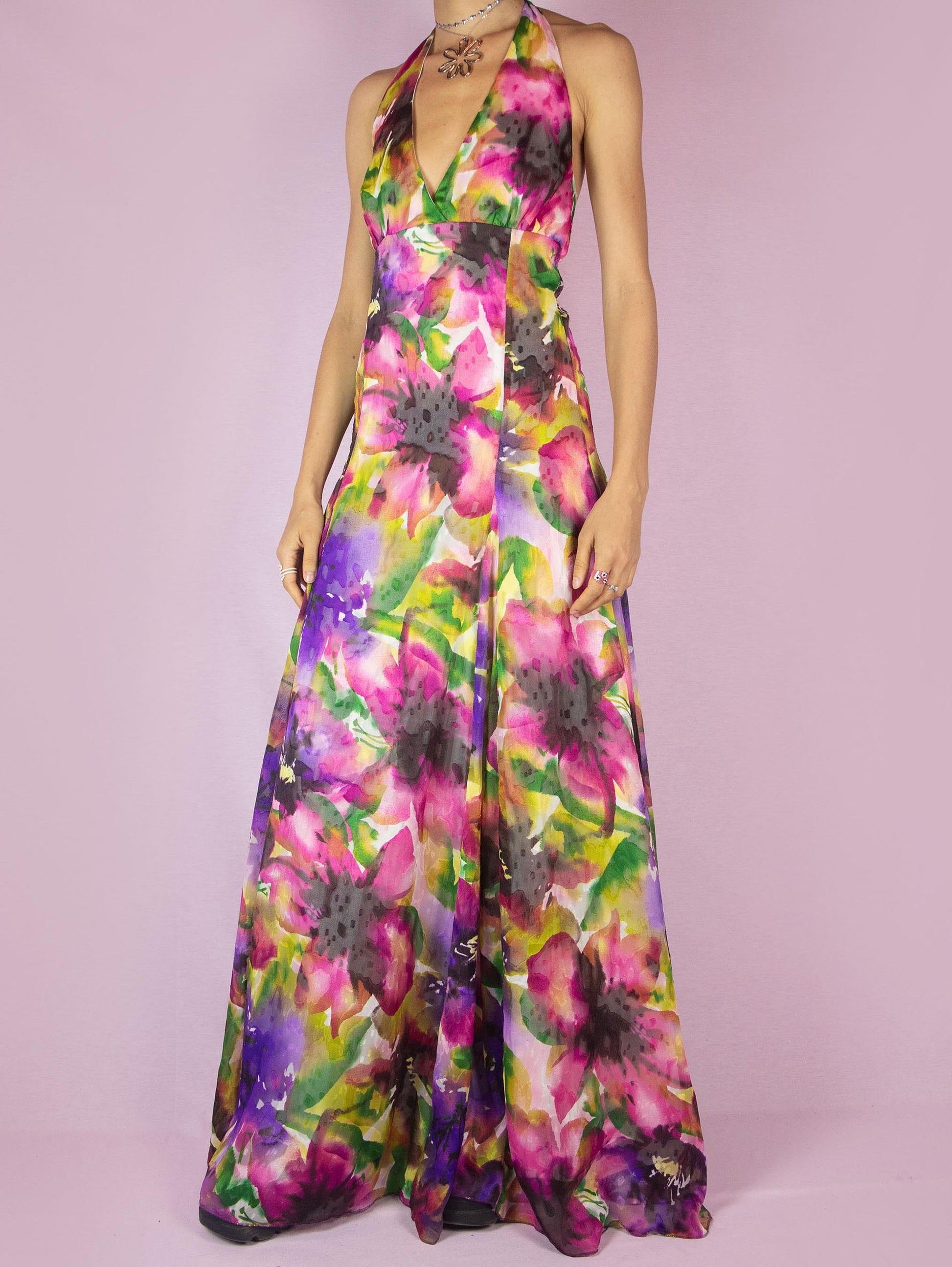 The Y2K Floral Halter Maxi Dress is a vintage 2000s formal party full circle dress with a deep v-neckline that ties at the neck and has a back zipper closure.