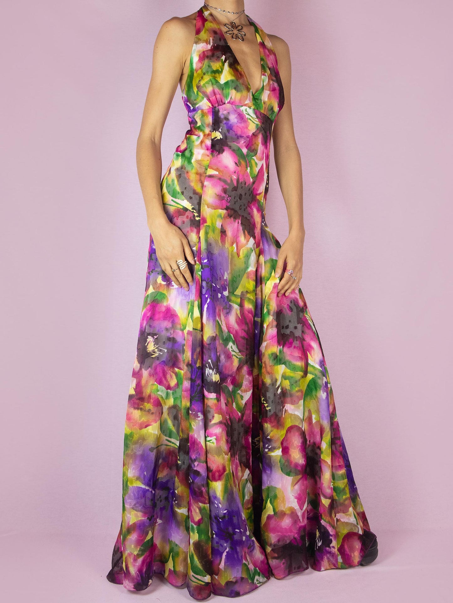 The Y2K Floral Halter Maxi Dress is a vintage 2000s formal party full circle dress with a deep v-neckline that ties at the neck and has a back zipper closure.