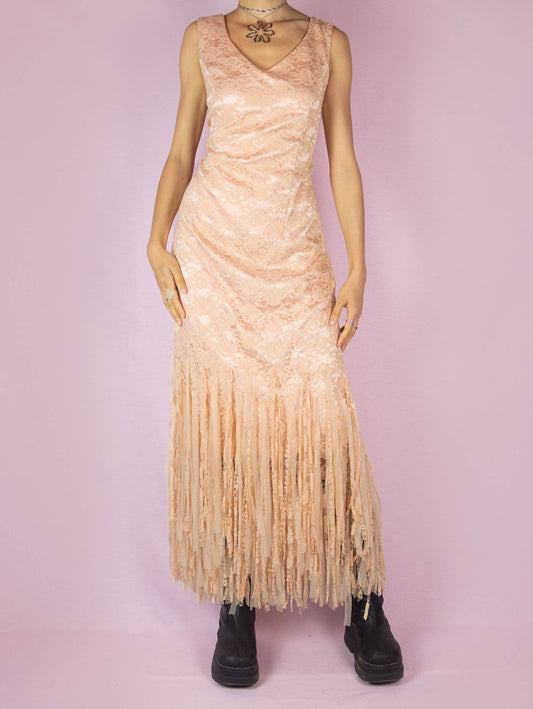 The Y2K Pink Lace Maxi Dress is a vintage 2000s romantic light salmon pink sleeveless party flapper dress with a side zipper closure and a tulle mesh fringed hem. Made in Spain.