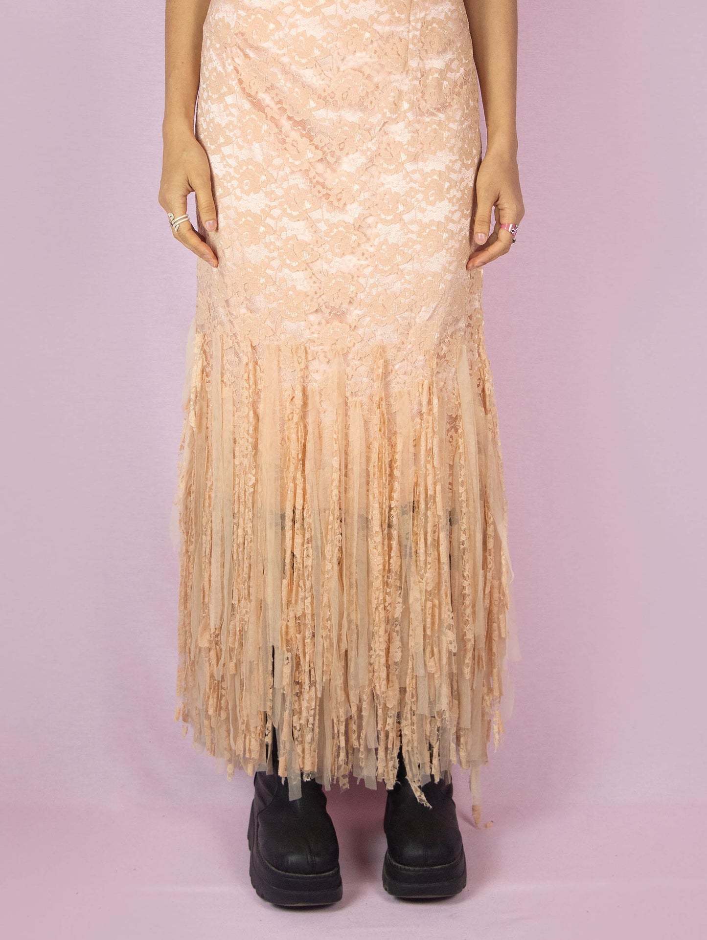 The Y2K Pink Lace Maxi Dress is a vintage 2000s romantic light salmon pink sleeveless party flapper dress with a side zipper closure and a tulle mesh fringed hem. Made in Spain.