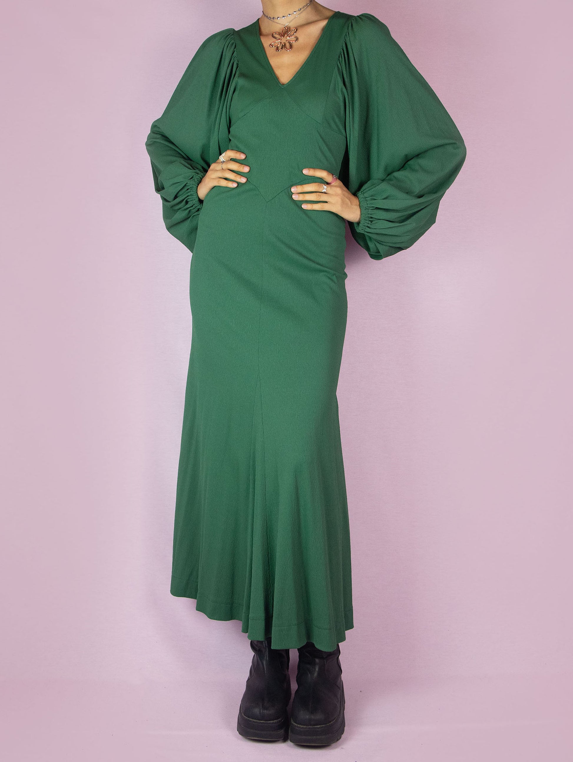 The Vintage 70s Green Maxi Dress is a slightly stretchy, romantic prairie country western-inspired elegant party midi dress with a V-neck, balloon sleeves, fitted waist, and back zipper closure.