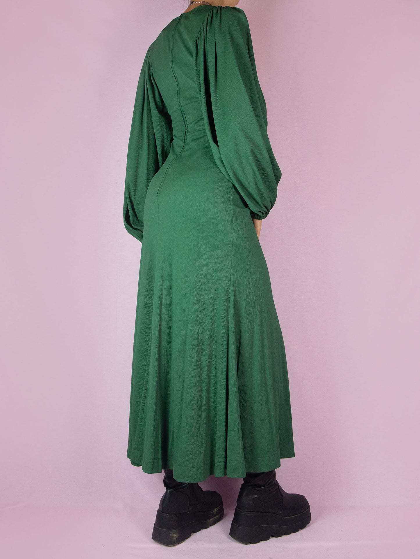 The Vintage 70s Green Maxi Dress is a slightly stretchy, romantic prairie country western-inspired elegant party midi dress with a V-neck, balloon sleeves, fitted waist, and back zipper closure.