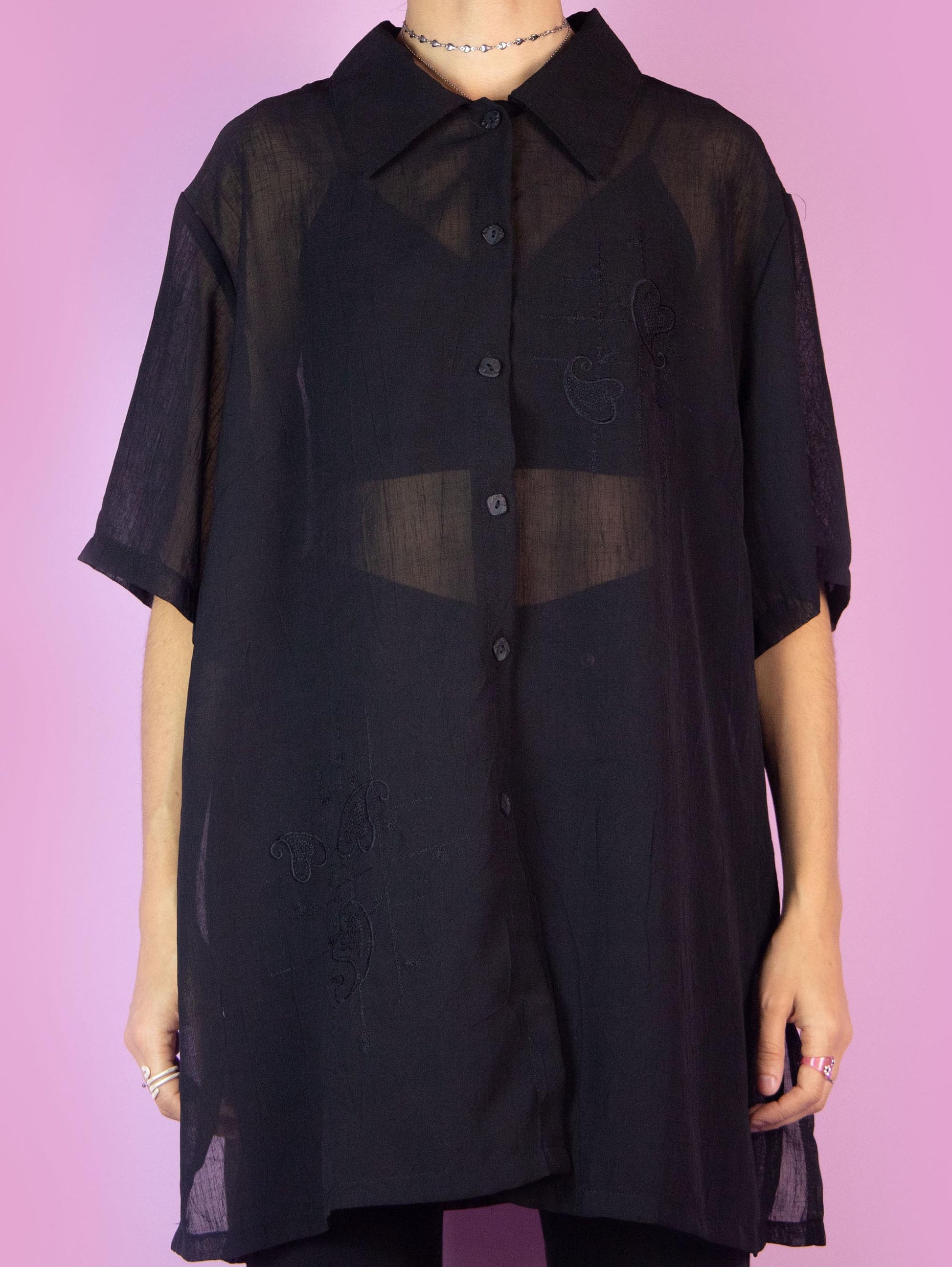 The Y2K Black Sheer Blouse is a vintage short-sleeved semi-transparent black shirt with a collar and buttons. Boho grunge 2000s summer shirt.