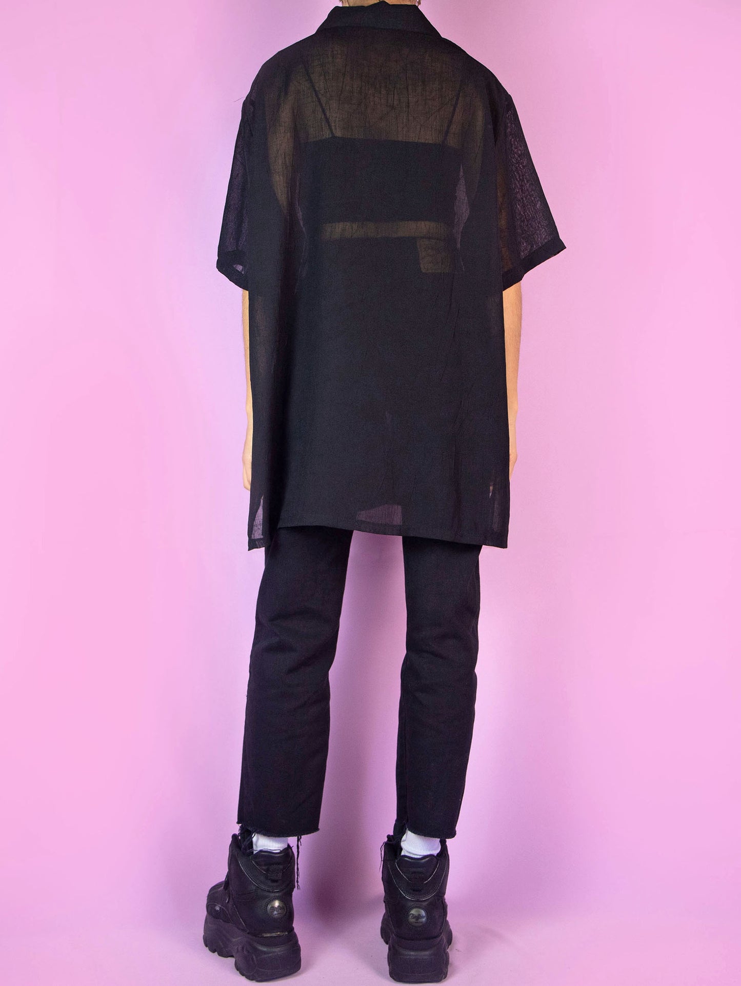 The Y2K Black Sheer Blouse is a vintage short-sleeved semi-transparent black shirt with a collar and buttons. Boho grunge 2000s summer shirt.