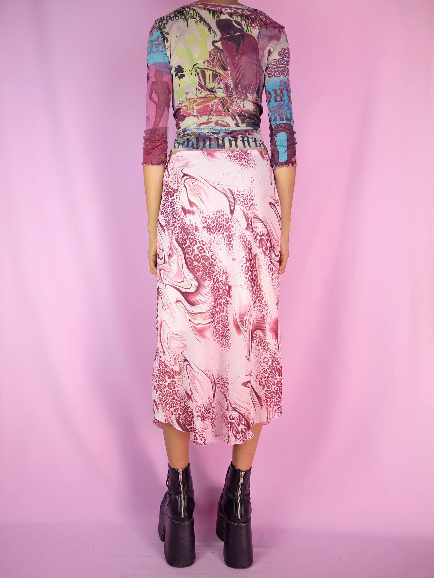 The Y2K Boho Pink Midi Skirt is a vintage pastel light pink and burgundy abstract print skirt with an elasticated waist and a pointed hem. Cyber fairy grunge 2000s summer maxi skirt.