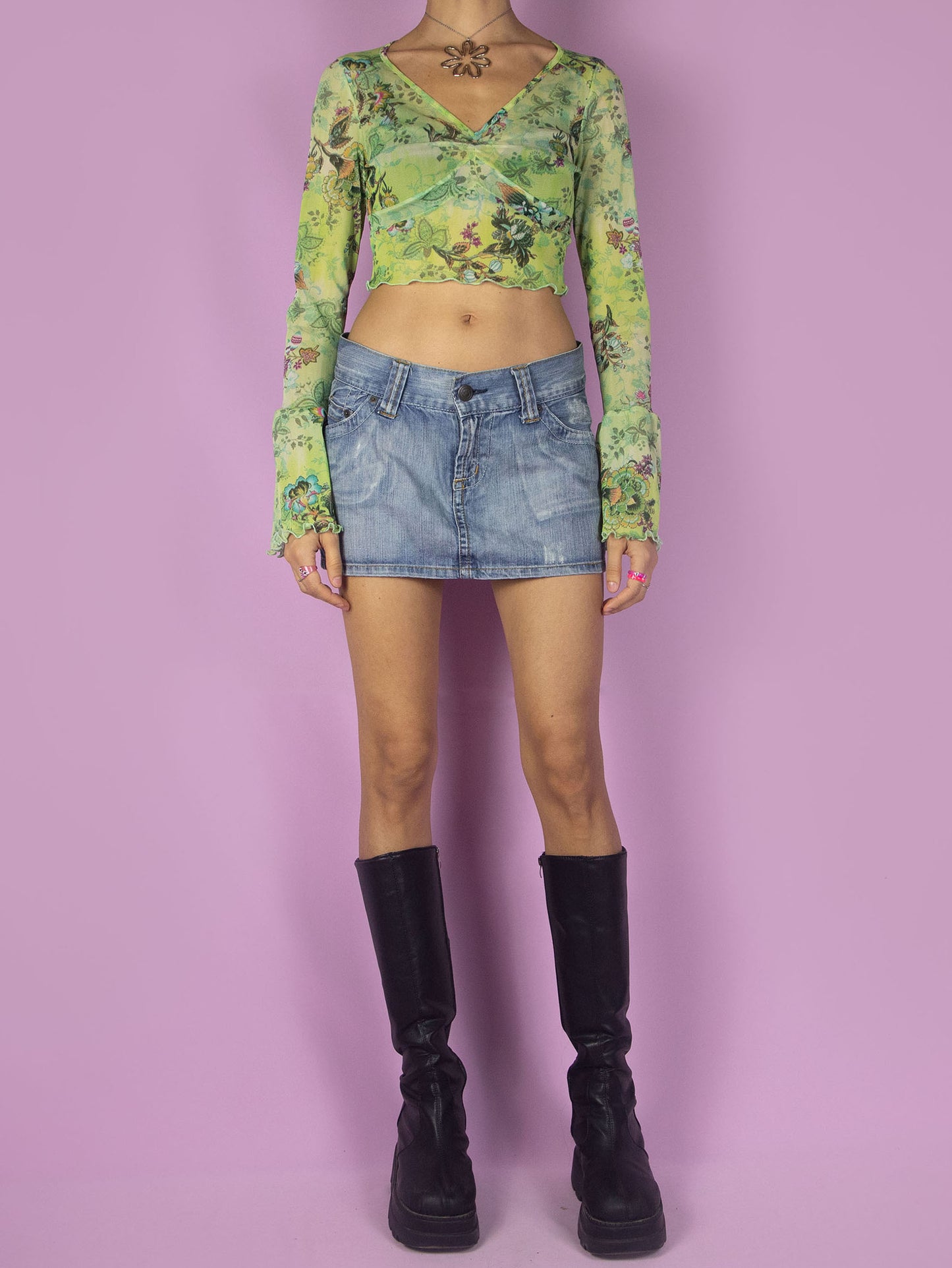 The Y2K Graphic Mesh Crop Top is a vintage bell-sleeved semi-sheer green shirt with an abstract floral pattern and a lettuce hem. Cyber fairy grunge 2000s printed top.